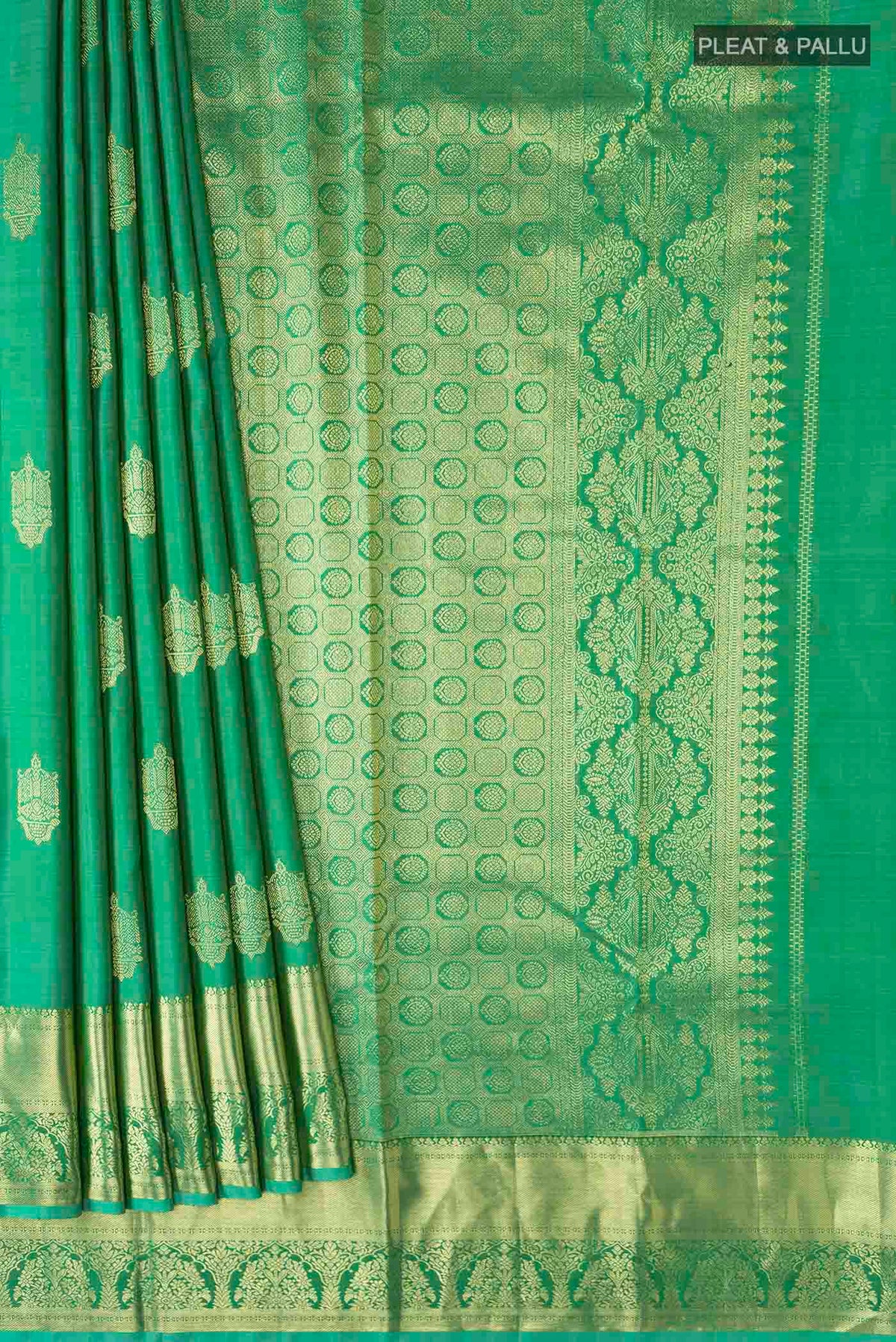 Pleats and pallu of Green Kanchipuram Silk Saree with Zari Butta on the body and Zari Border