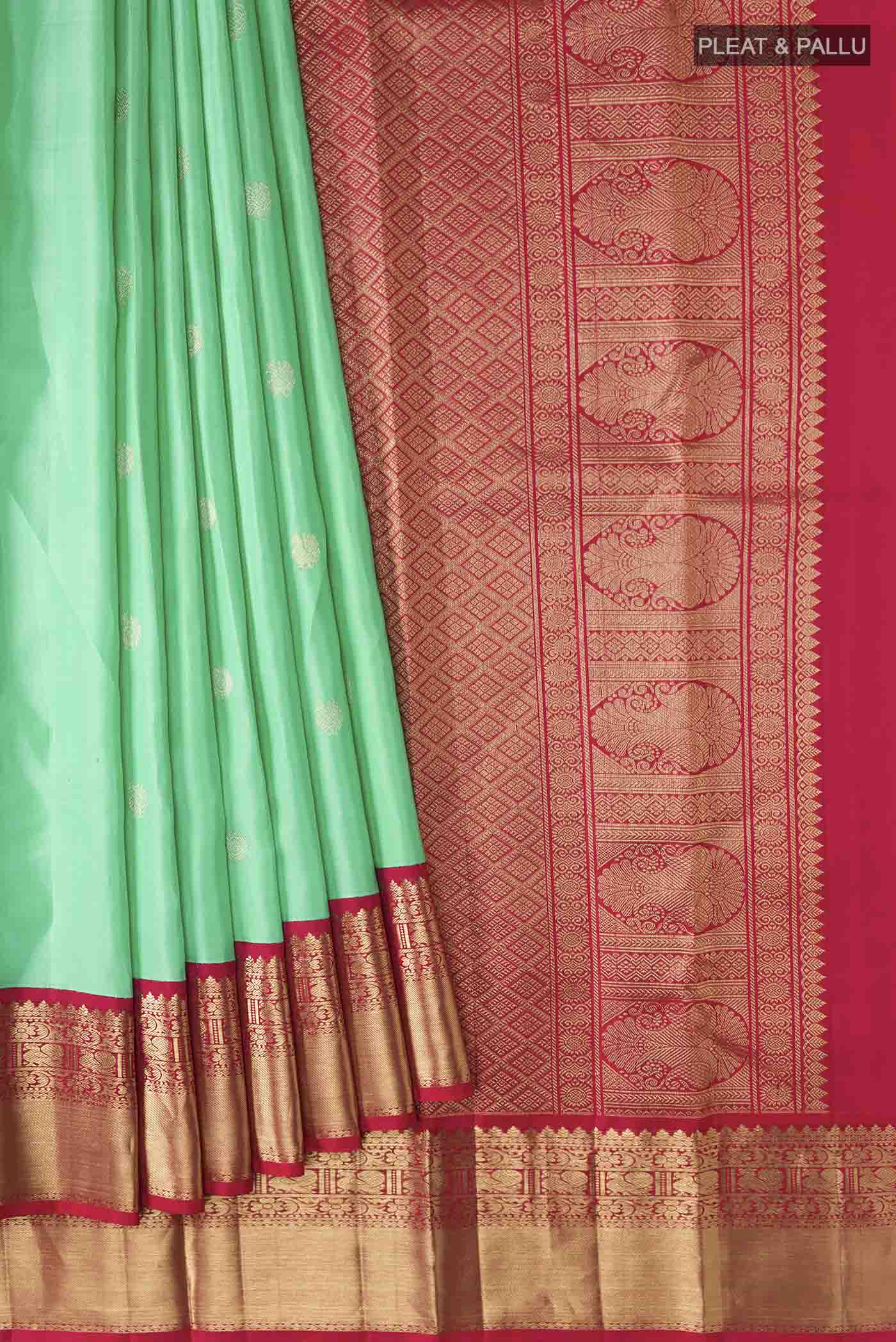 Pleats and pallu of Green Kanchipuram Silk Saree with Zari Butta on the body and Zari Border
