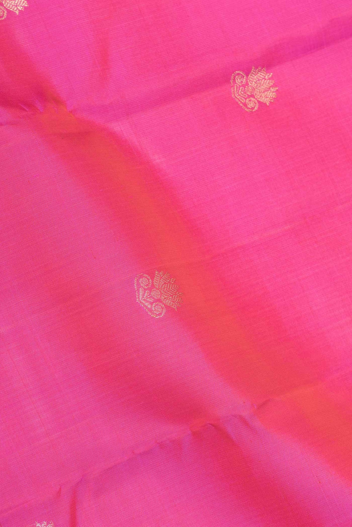Close up of Pink Dual Tone Kanchipuram Silk Saree with Zari Butta on the body and Zari Border displaying folds