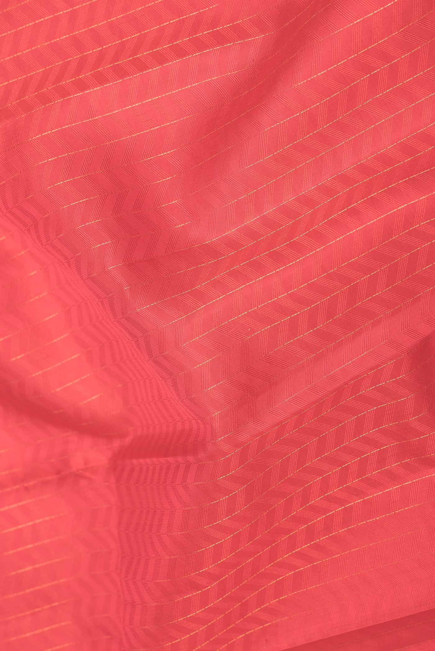 Close up of Red Dual Tone Kanchipuram Saree with Jacquard With Zari Butta on the body and Zari And Thread Border displaying folds