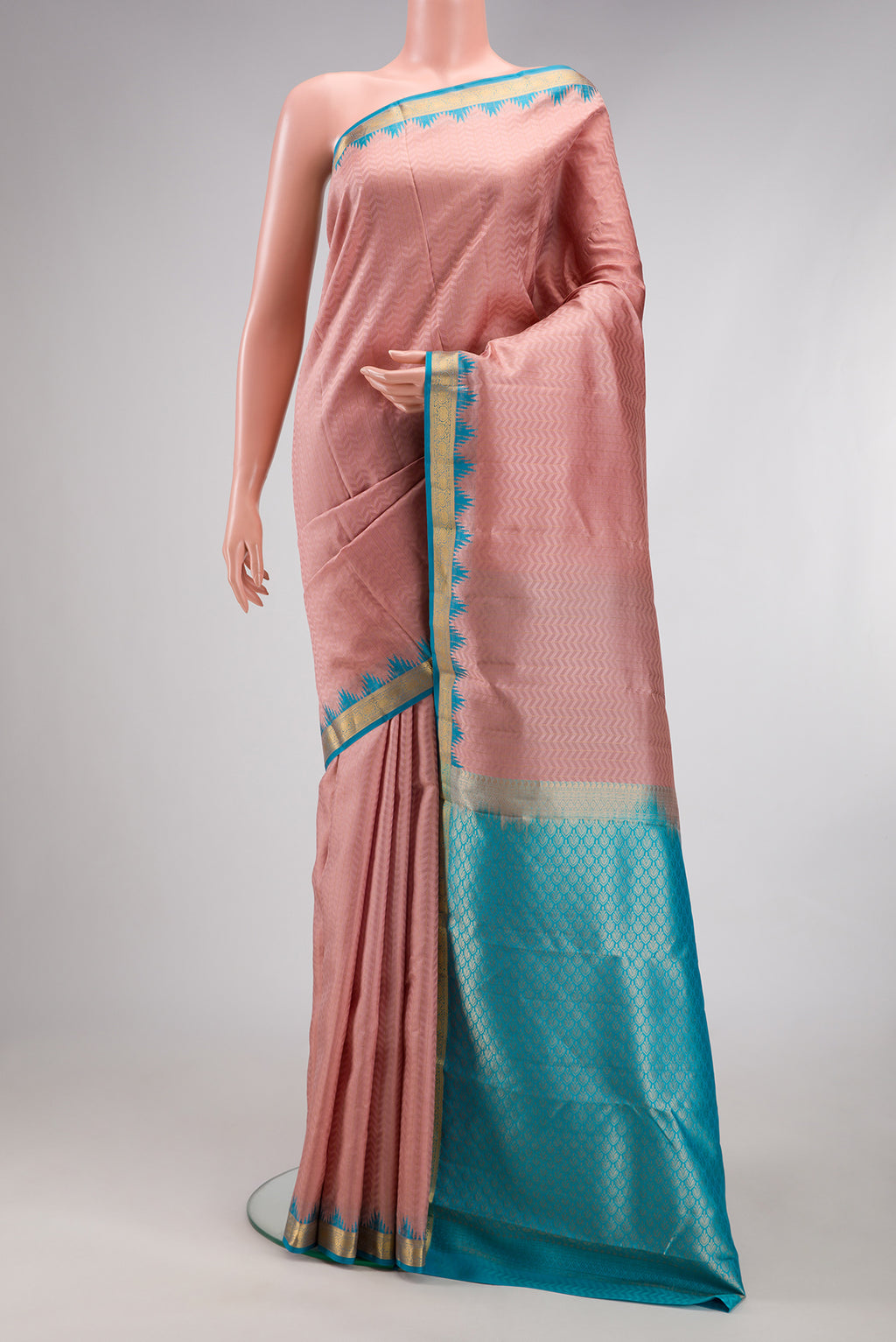 Rose Gold Kanjivaram Silk Saree with Jacquard design on the body and Temple Border.  displayed on a mannequin