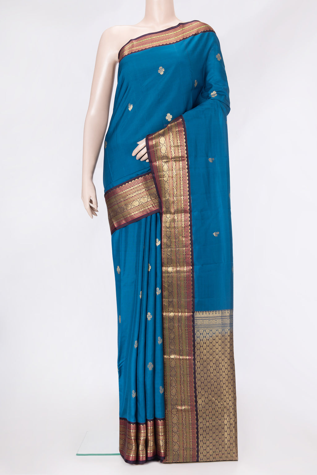 Peacock Blue Dual Tone Kanchipuram Silk Saree with Zari Butta on the body and Zari Border.  displayed on a mannequin