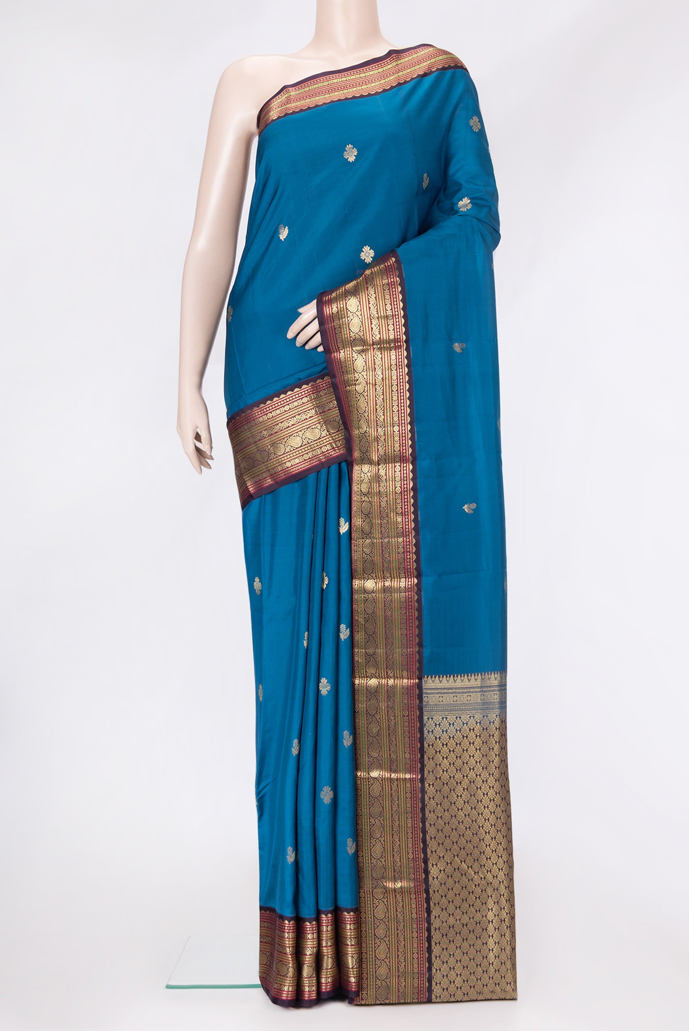 Peacock Blue Dual Tone Kanchipuram Silk Saree with Zari Butta on the body and Zari Border.  displayed on a mannequin