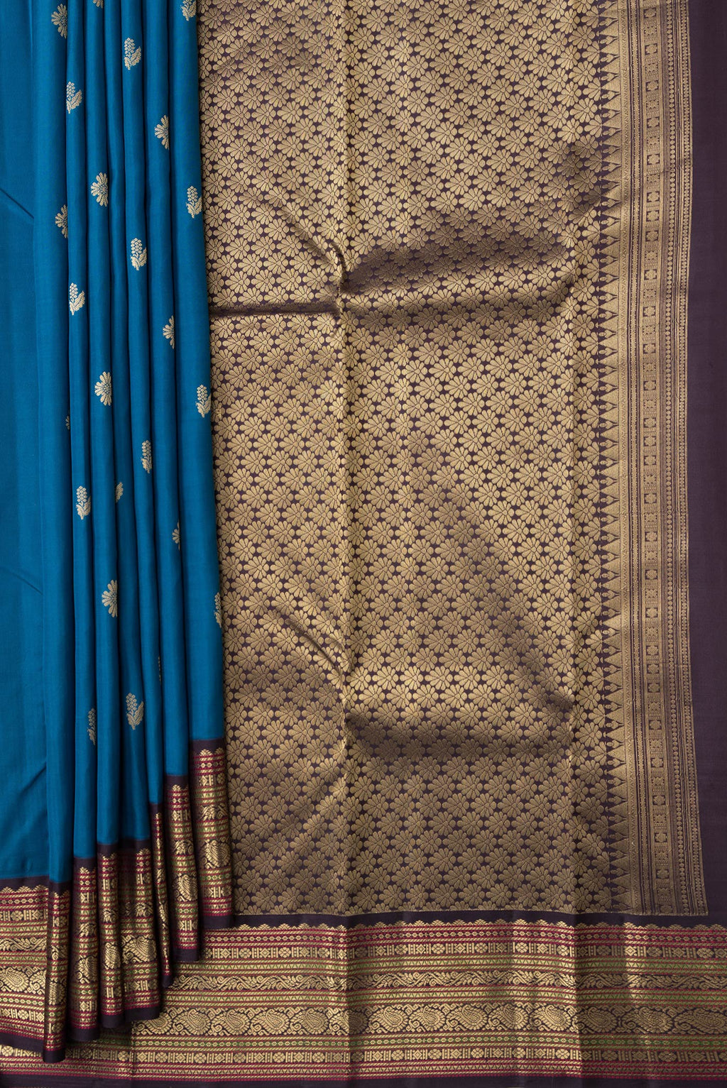 Pleats and pallu of Peacock Blue Dual Tone Kanchipuram Silk Saree with Zari Butta on the body and Zari Border. 