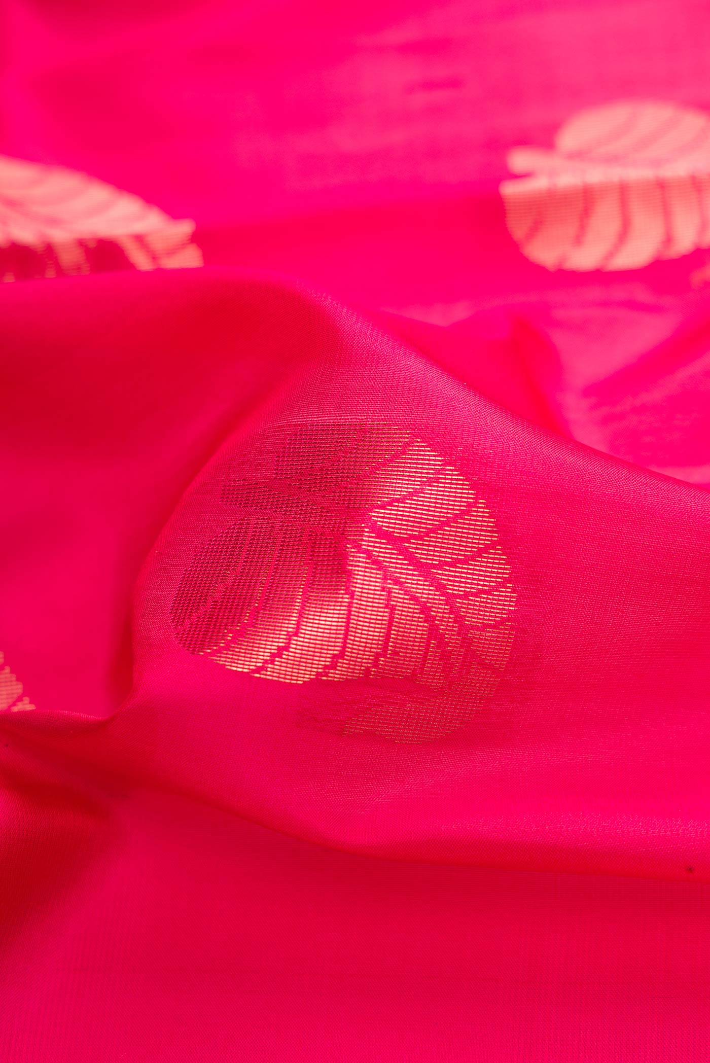 Close up of Pink Dual Tone Soft Silk Saree with Zari Butta on the body and Zari Border.  displaying folds