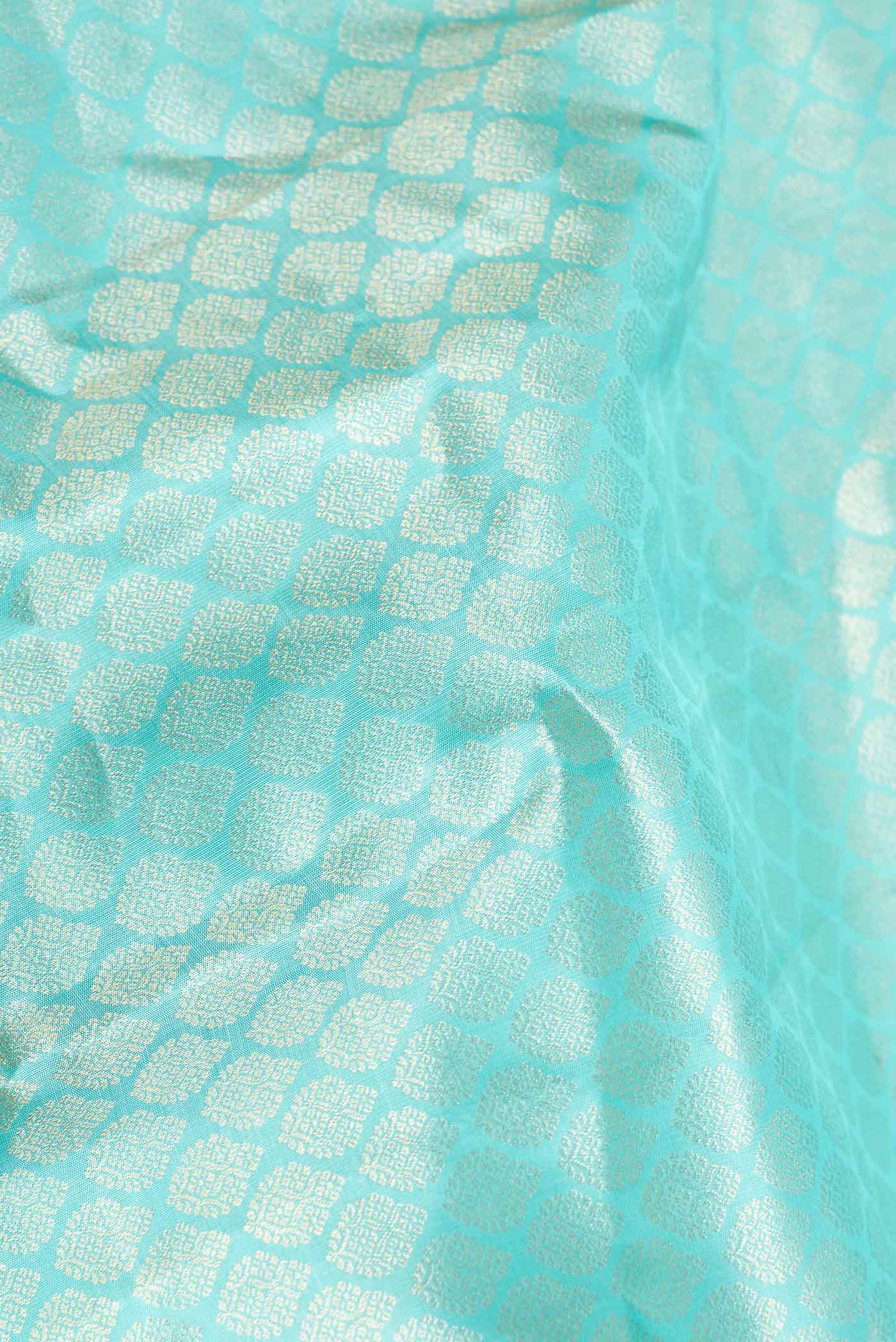 Close up of Sky Blue Dual Tone Kanchipuram Saree with Zari Brocade on the body and Zari Border displaying folds