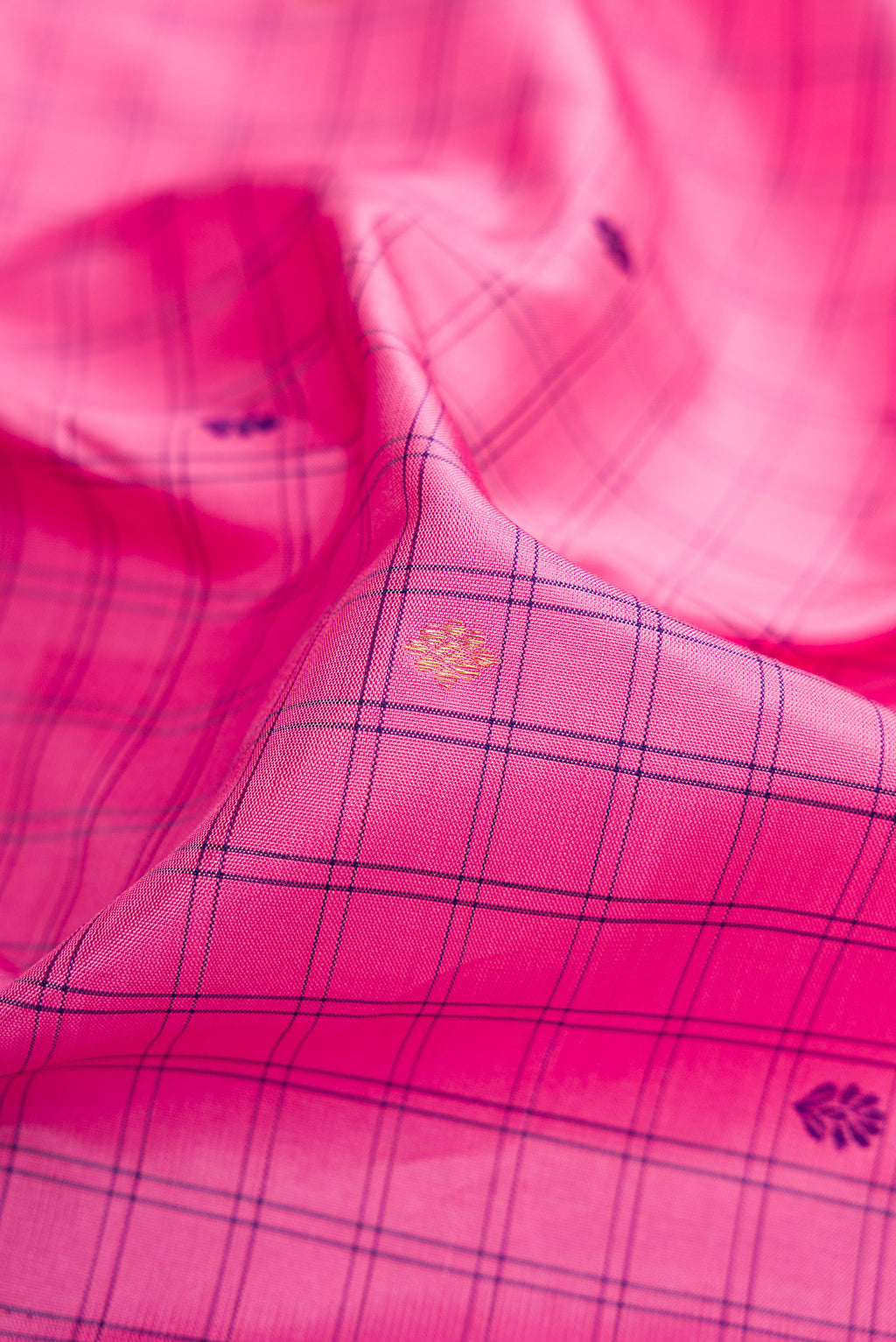 Close up of Pure Silk Pure Zari Pink Dual Tone Kanjivaram Saree with Checked design on the body and Zari Border.  displaying folds