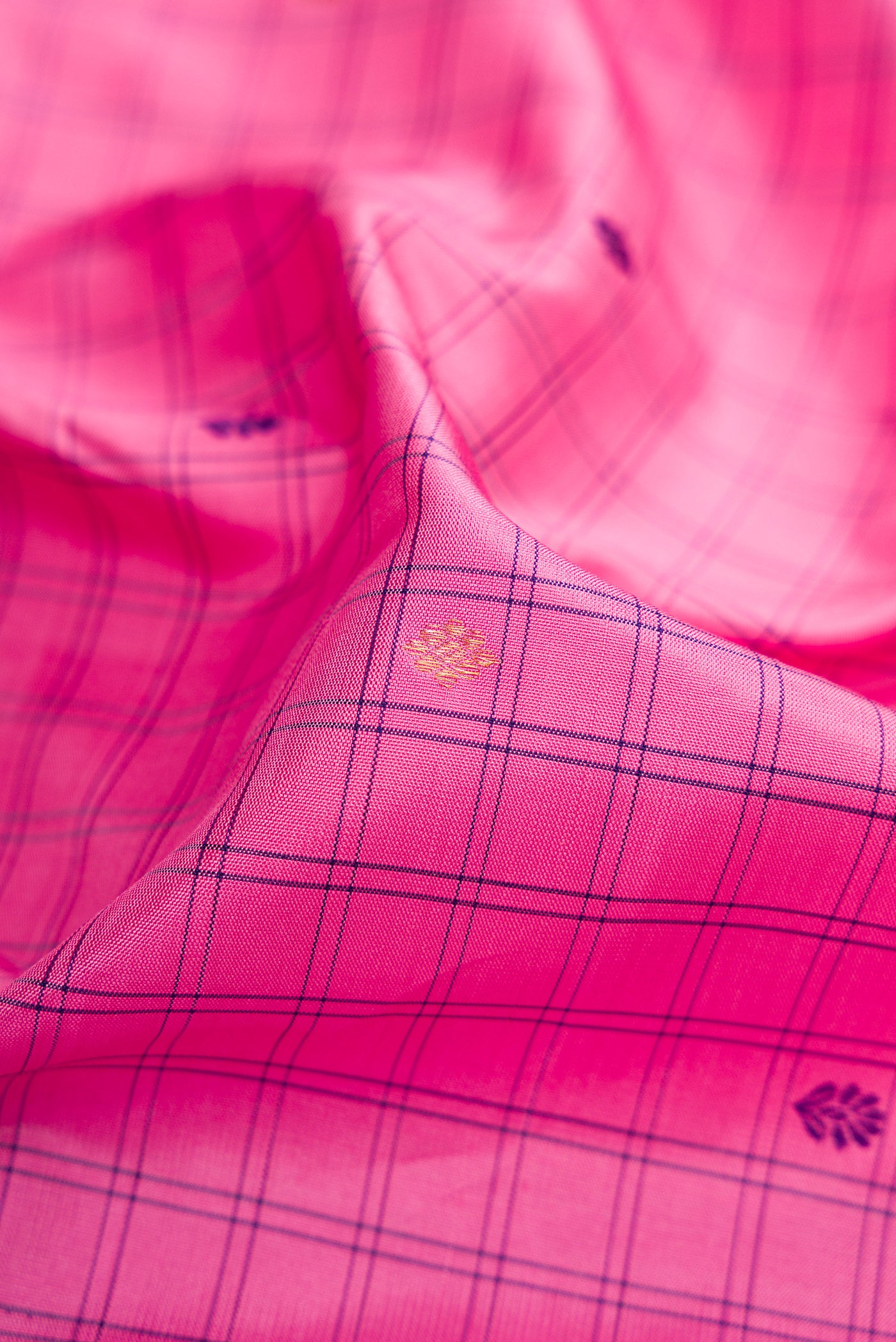Close up of Pure Silk Pure Zari Pink Dual Tone Kanjivaram Saree with Checked design on the body and Zari Border.  displaying folds