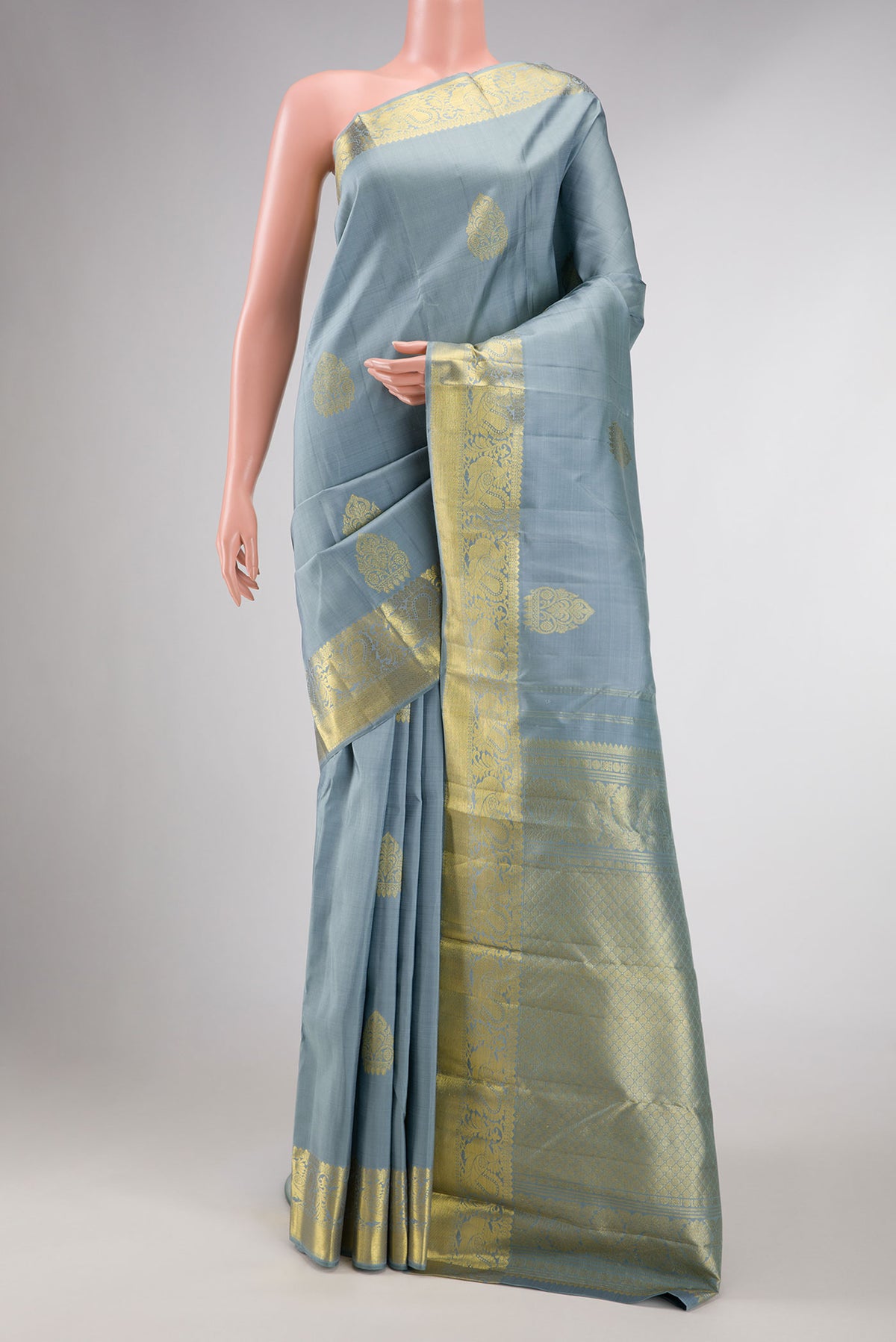 Grey Dual Tone Kanchipuram Silk Saree with Zari Butta on the body and Zari Border displayed on a mannequin