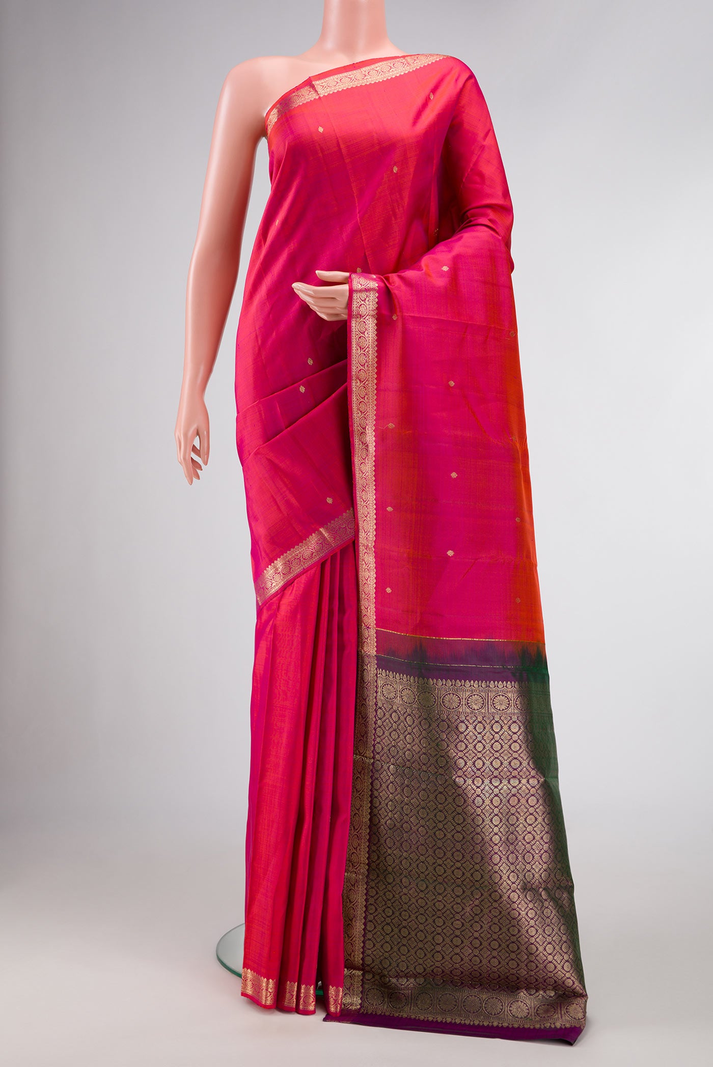 Coral Dual Tone Kanjivaram Silk Saree with Zari Butta on the body and Zari Border.  displayed on a mannequin