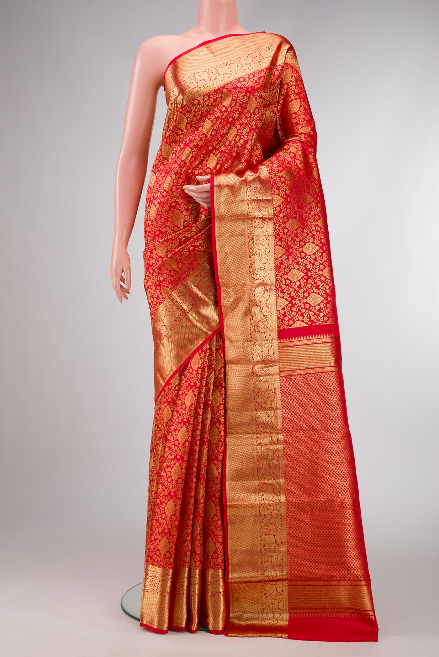 Red Dual Tone Kanchipuram Silk Saree with Zari Brocade on the body and Zari Border.  displayed on a mannequin
