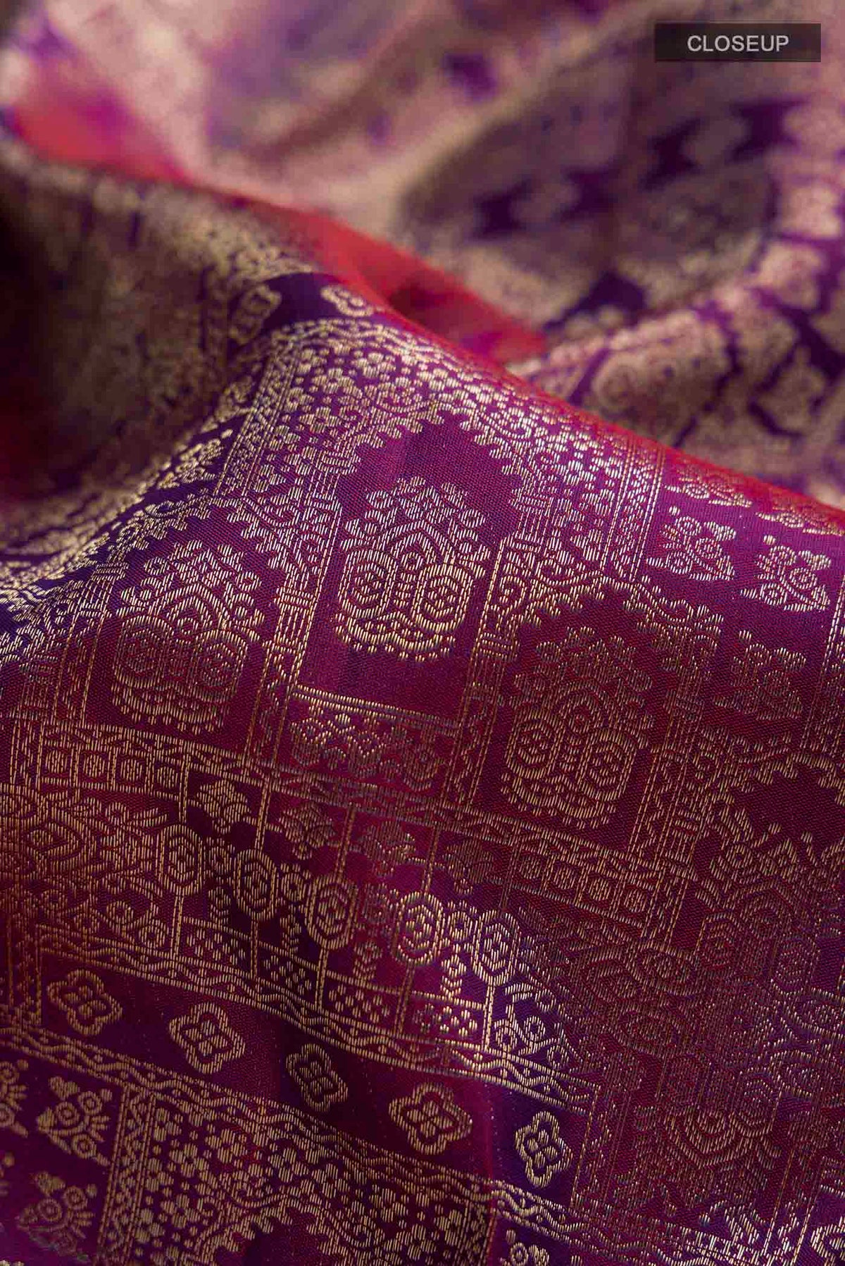 Close up of Violet Kanchipuram Silk Saree with Zari Brocade on the body and Zari Border displaying folds