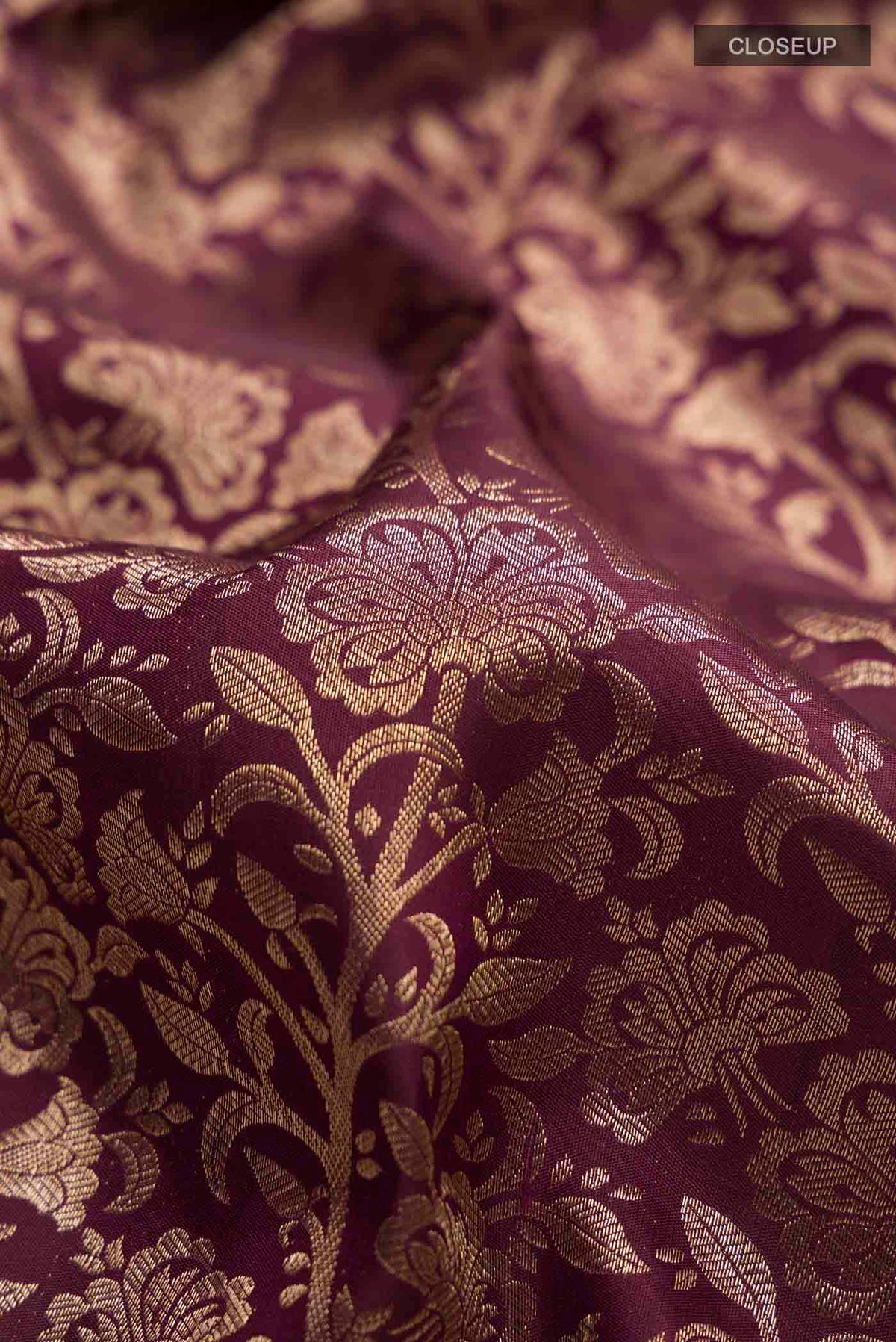 Close up of Maroon Kanchipuram Silk Saree with Zari Brocade on the body and Zari Border displaying folds