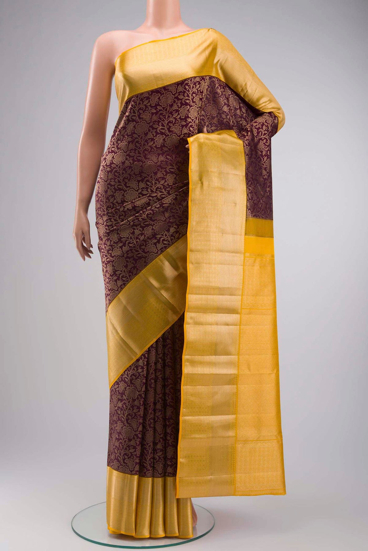 Maroon Kanchipuram Silk Saree with Zari Brocade on the body and Zari Border displayed on a mannequin