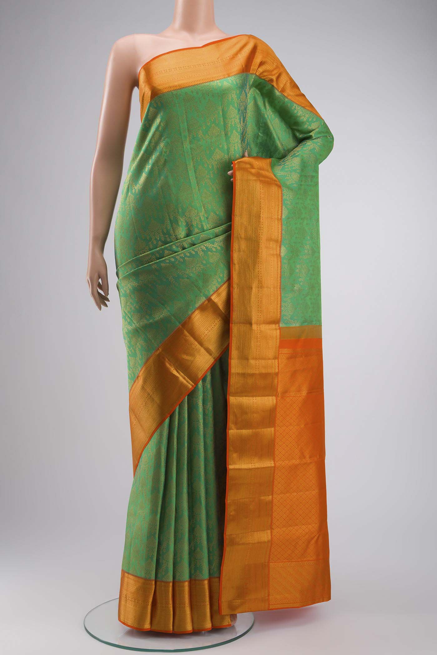 Green Kanchipuram Silk Saree with Zari Brocade on the body and Zari Border displayed on a mannequin