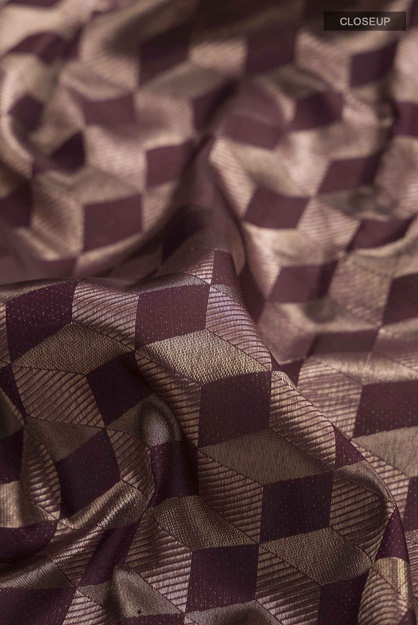 Close up of Brown Kanchipuram Silk Saree with Zari Brocade on the body and Zari Border displaying folds