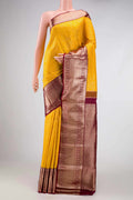 Yellow Dual Tone Kanchipuram Silk Saree with Zari Brocade on the body and Zari Border.  displayed on a mannequin