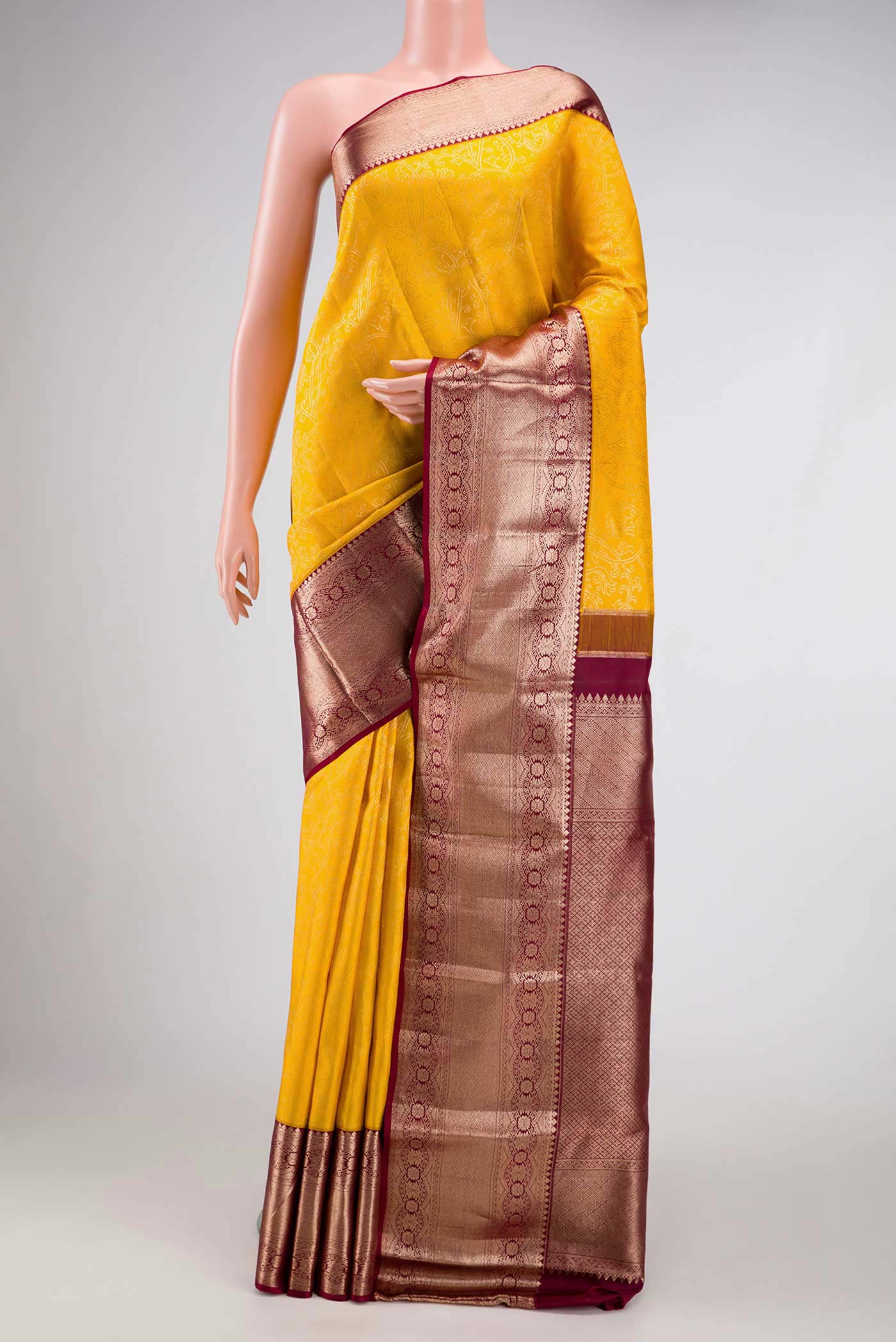 Yellow Dual Tone Kanchipuram Silk Saree with Zari Brocade on the body and Zari Border.  displayed on a mannequin