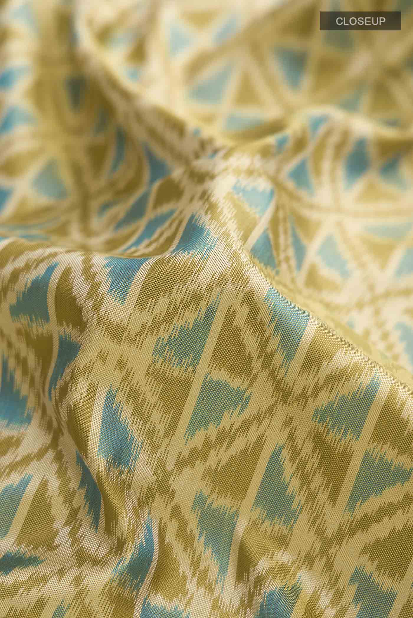 Close up of Green Pochampally Silk Saree with Pure Ikat on the body and Zari Border displaying folds