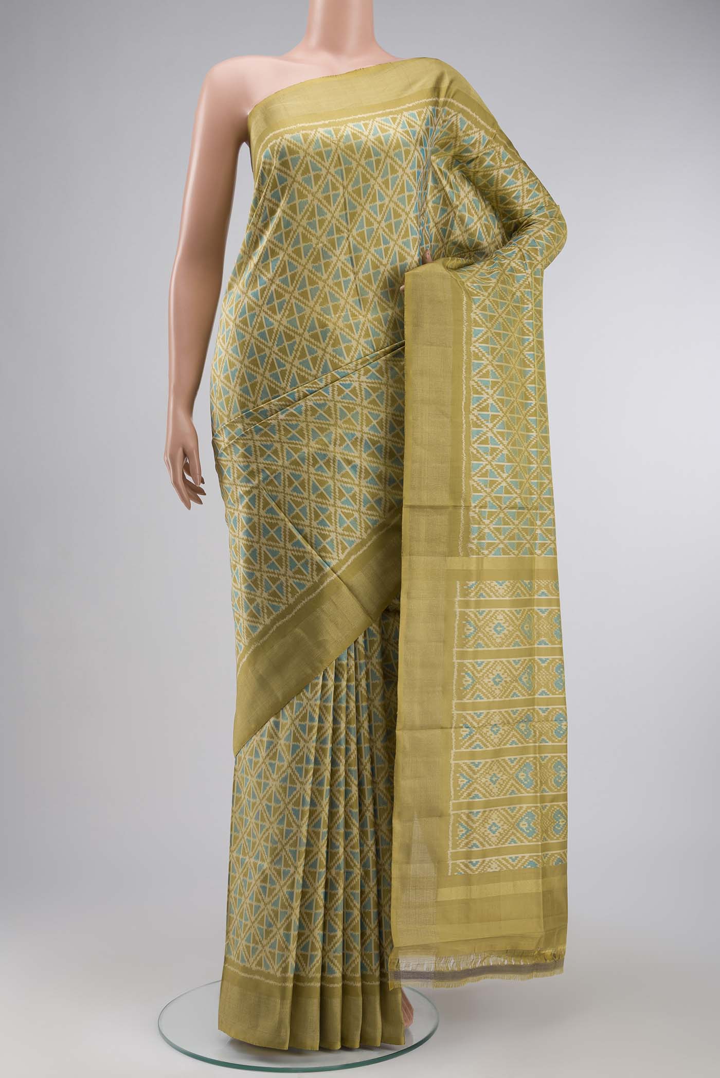 Green Pochampally Silk Saree with Pure Ikat on the body and Zari Border displayed on a mannequin