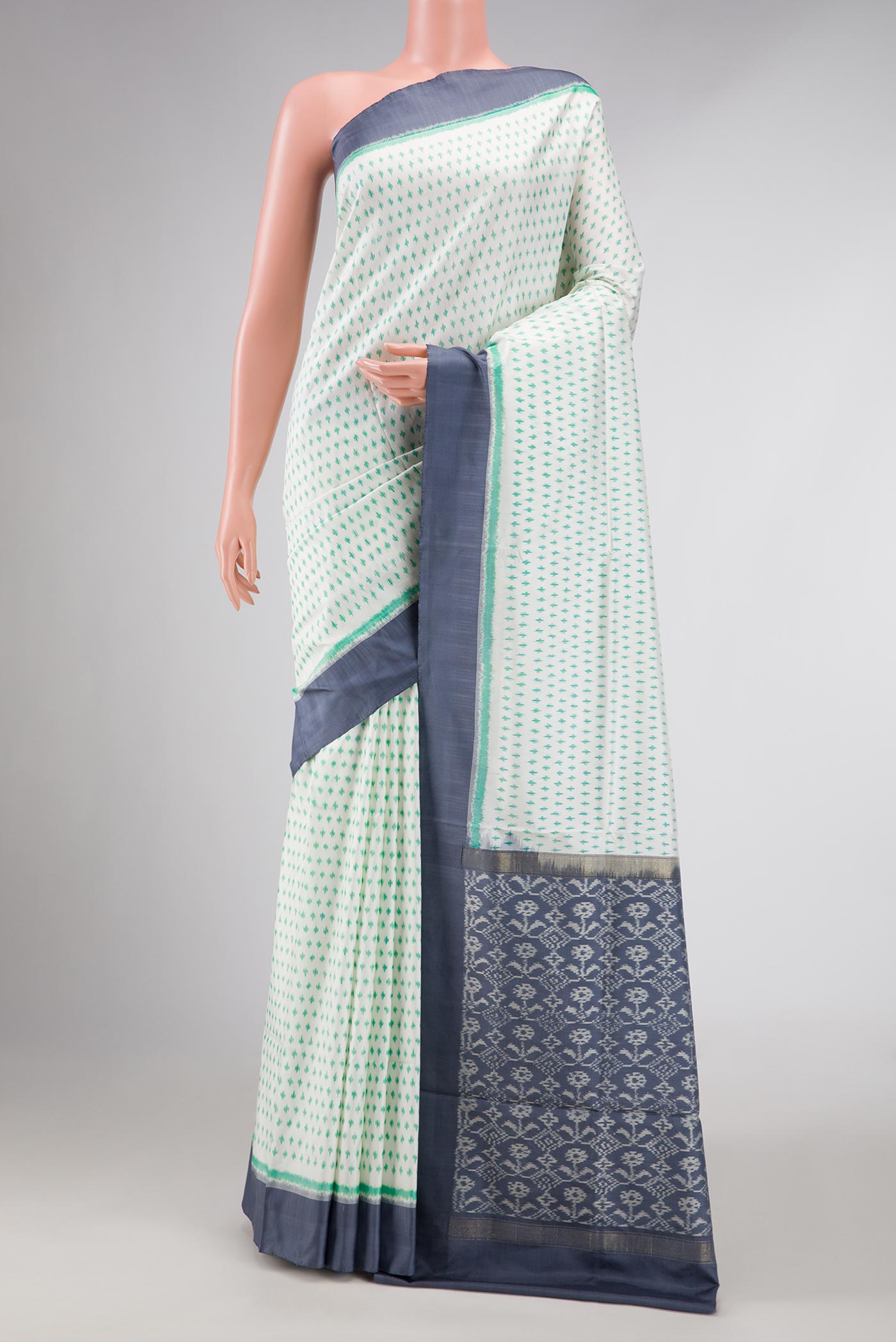 Off White Dual Tone Double Ikat Saree with Ikat Print on the body and Zari Border displayed on a mannequin