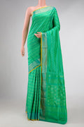 Green Dual Tone Double Ikat Saree with Ikat Print on the body and Zari Border displayed on a mannequin