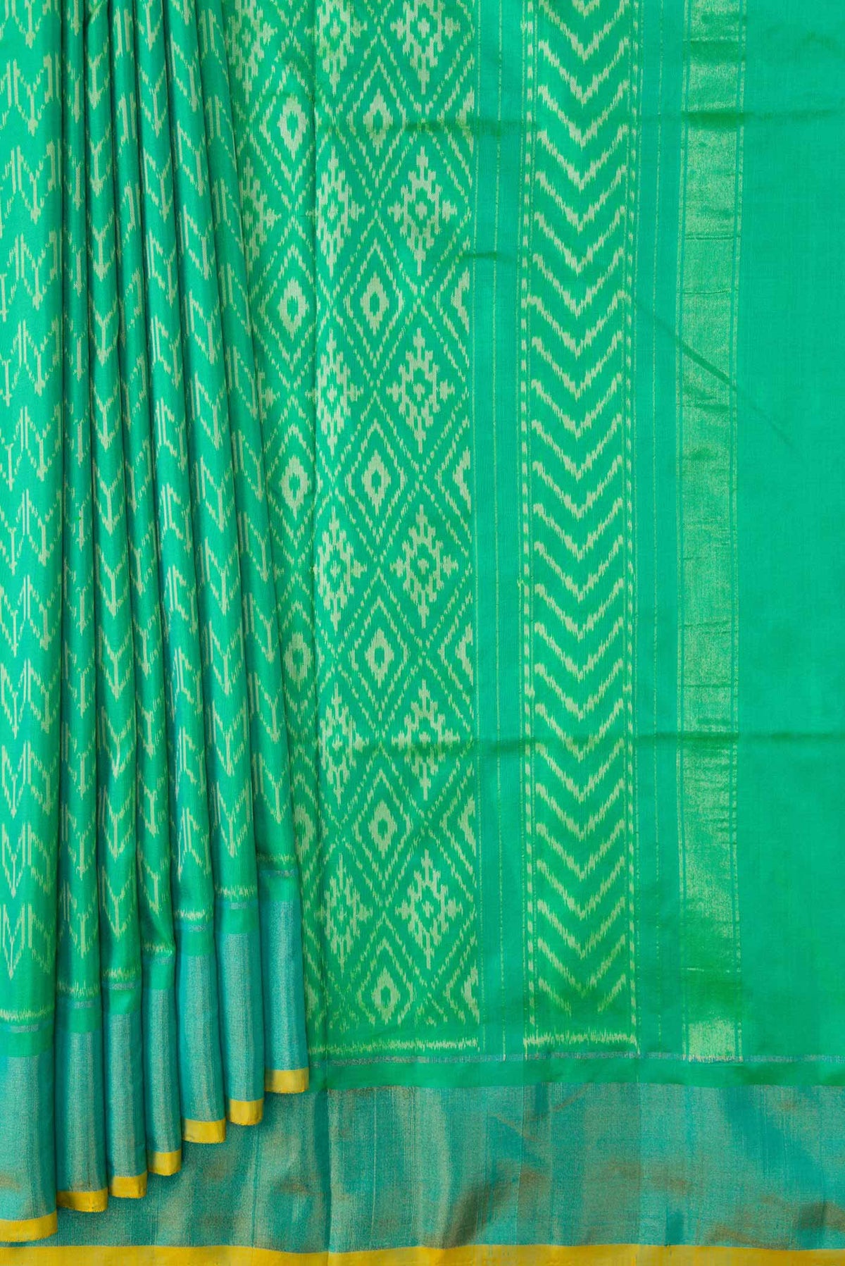 Pleats and pallu of Green Dual Tone Double Ikat Saree with Ikat Print on the body and Zari Border