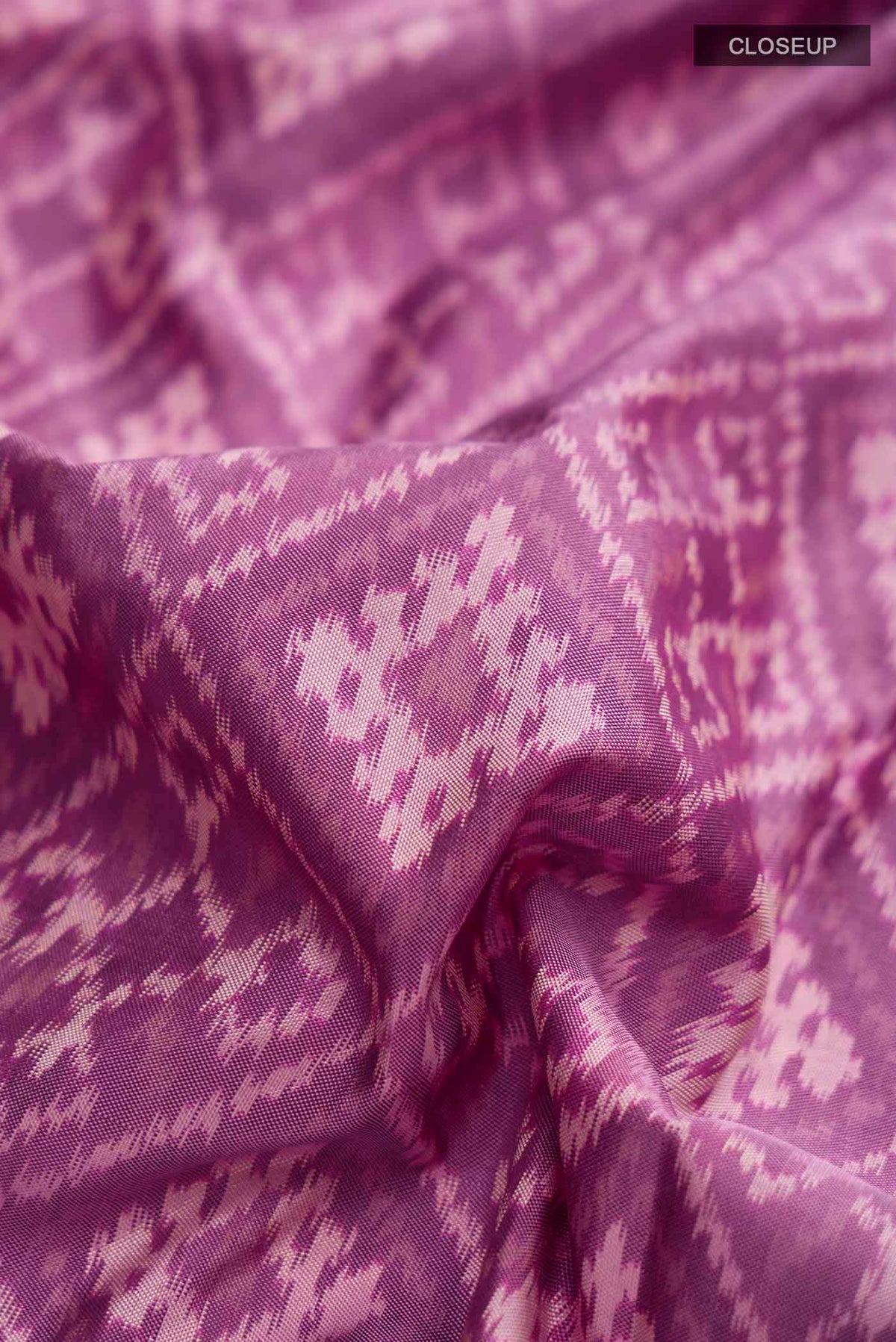 Close up of Lavender Pochampally Silk Saree with Pure Ikat on the body and Zari Border displaying folds