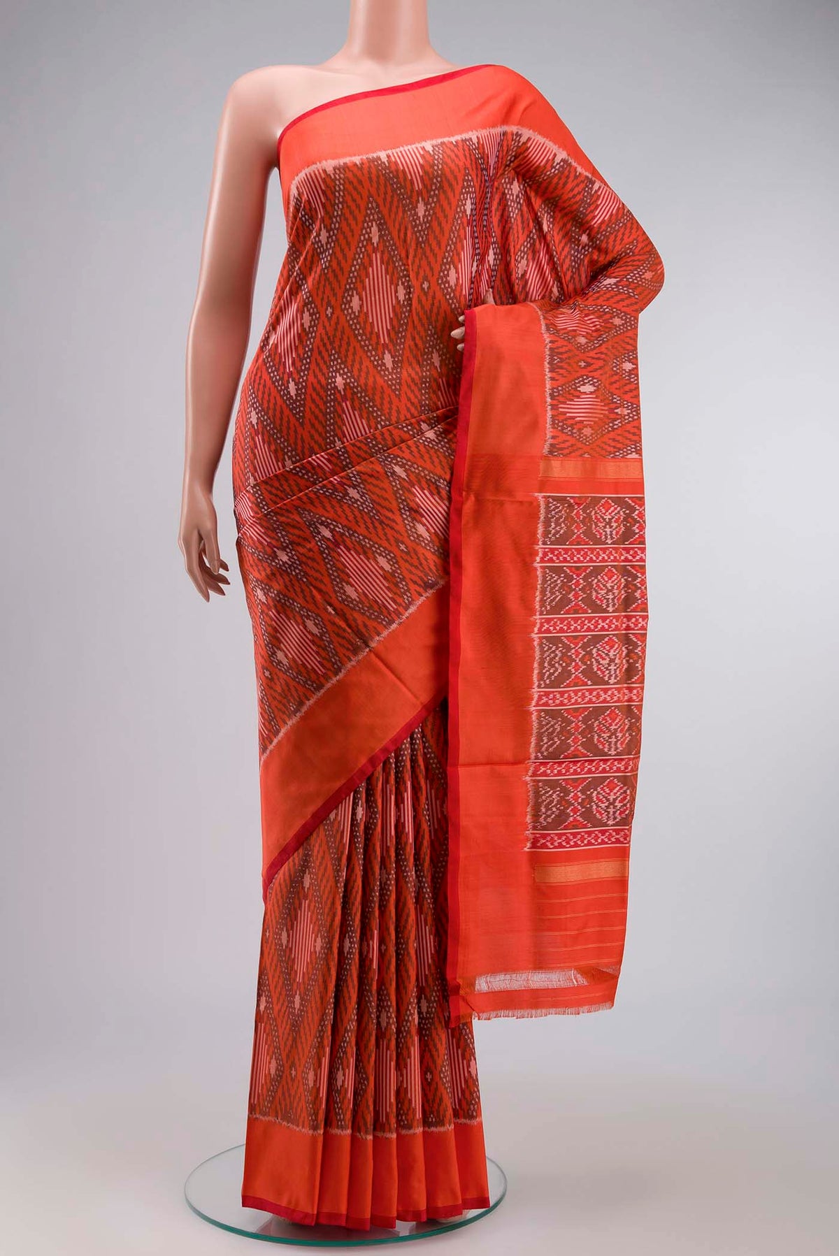Orange Pochampally Silk Saree with Pure Ikat on the body and Plain Border displayed on a mannequin