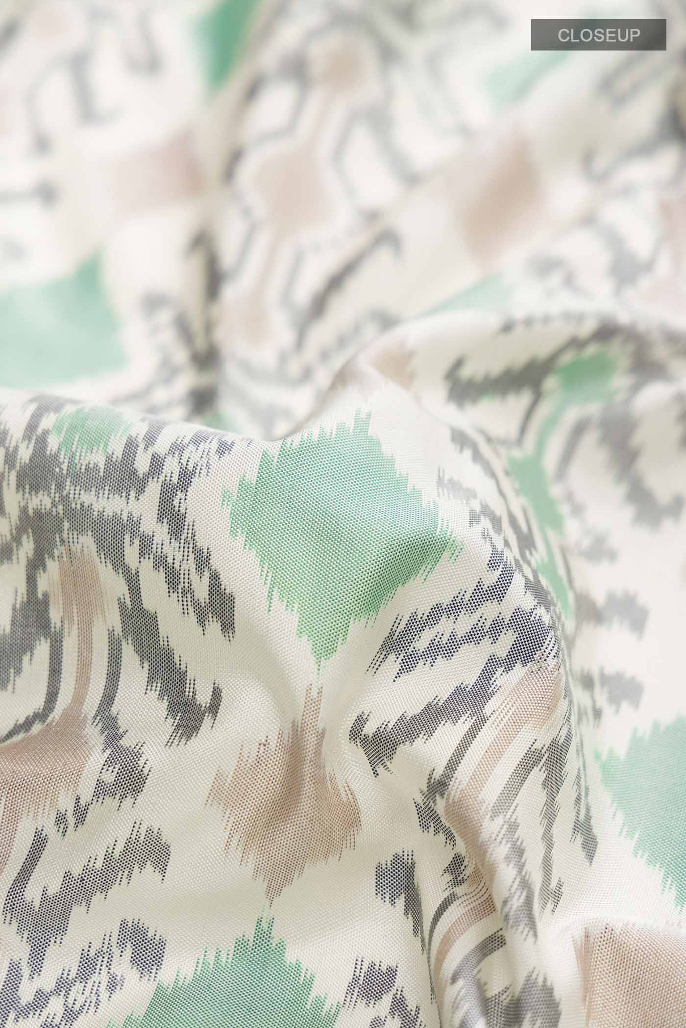 Close up of White Pochampally Silk Saree with Pure Ikat on the body and Zari Border displaying folds
