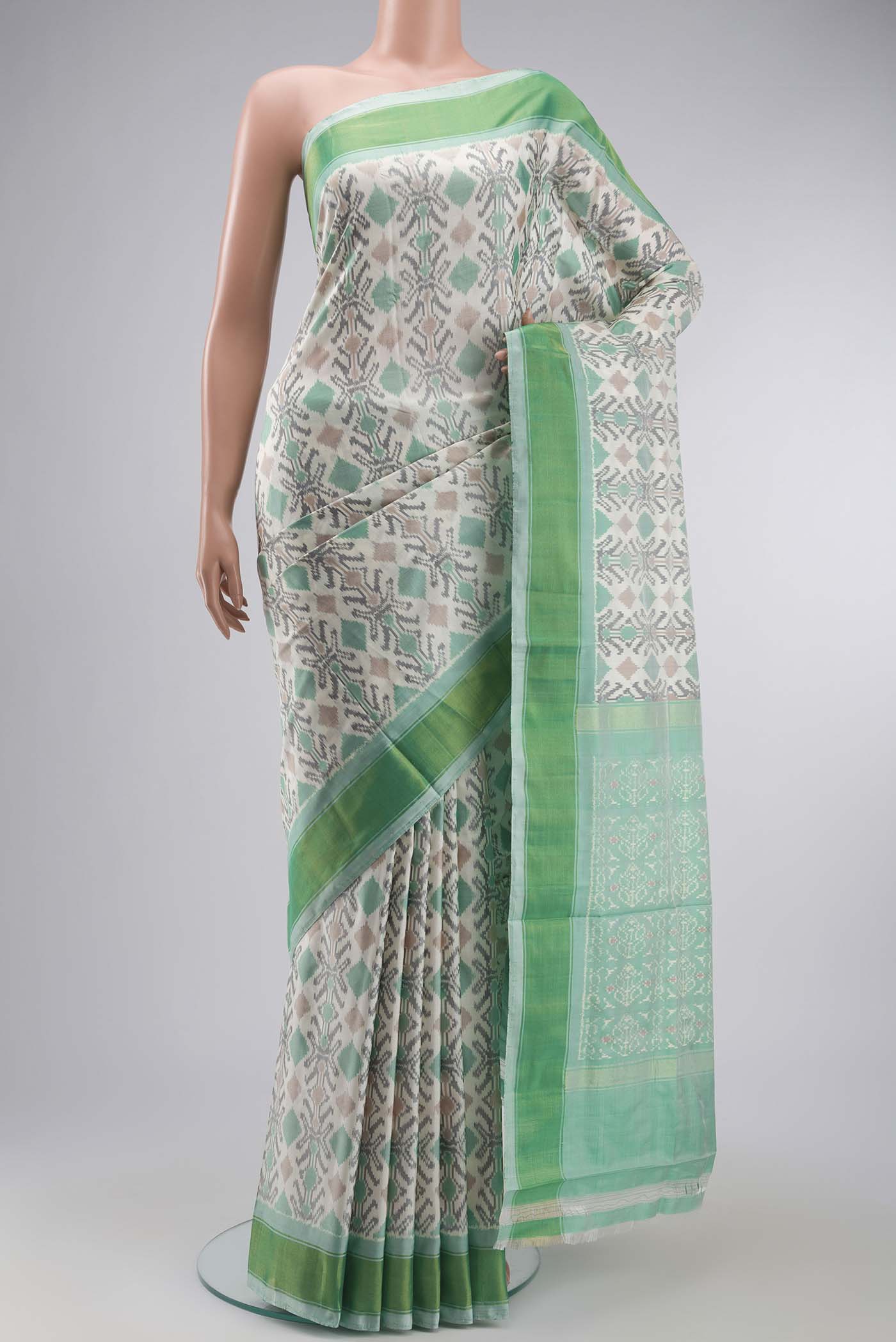 White Pochampally Silk Saree with Pure Ikat on the body and Zari Border displayed on a mannequin