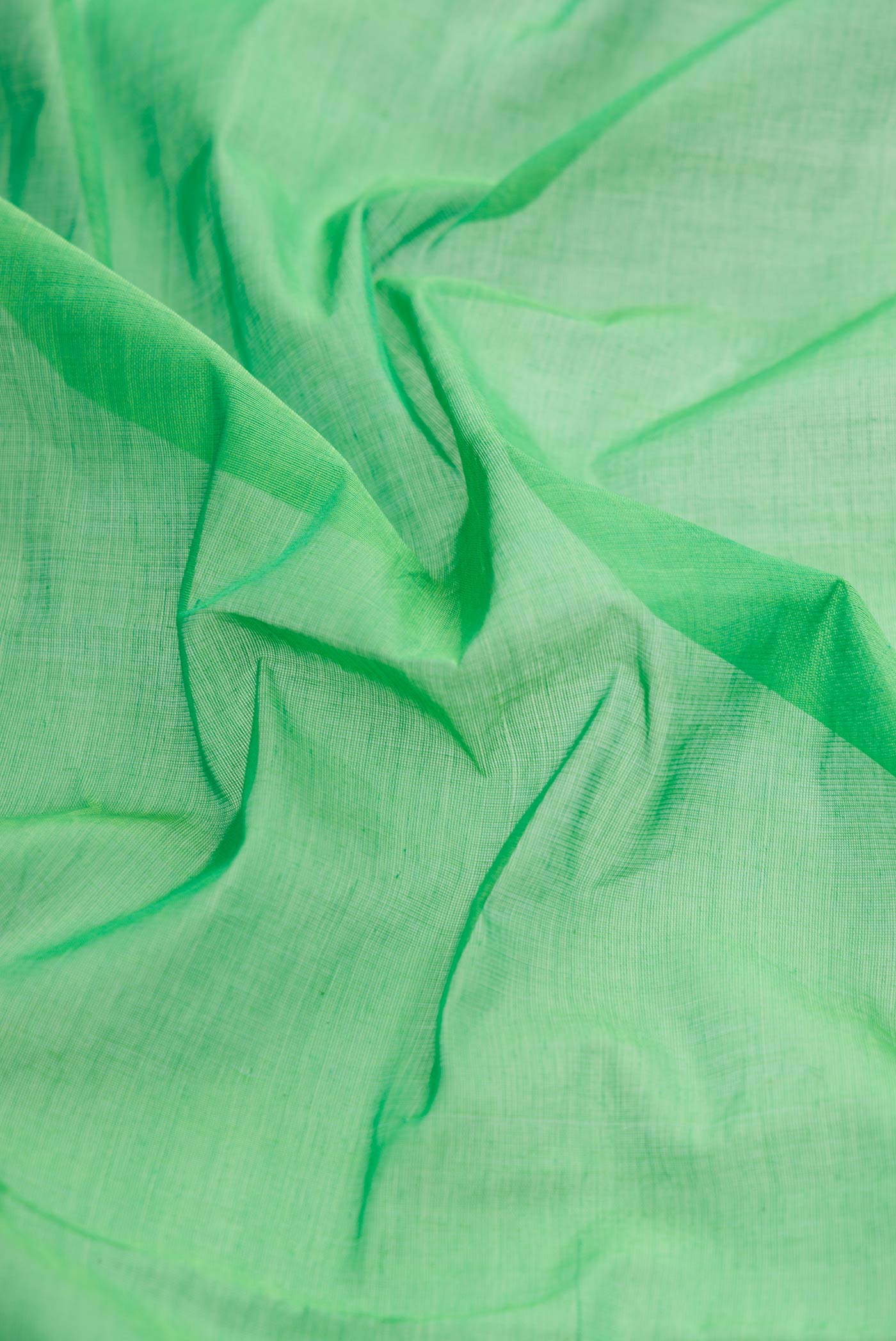 Close up of Green Dual Tone Uppada Cotton Saree with Plain Body and Plain Border displaying folds