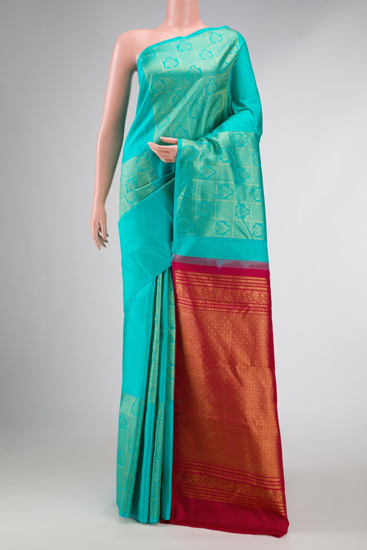 Sky Blue Dual Tone Kanchipuram Silk Saree with Zari Butta on the body and Without Border displayed on a mannequin