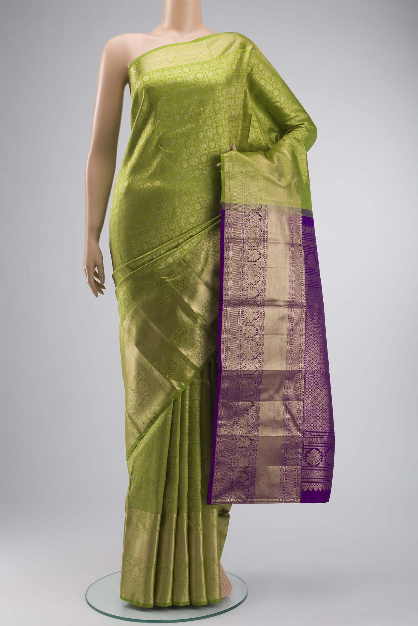 Green Kanchipuram Silk Saree with Zari Brocade on the body and Zari Border displayed on a mannequin