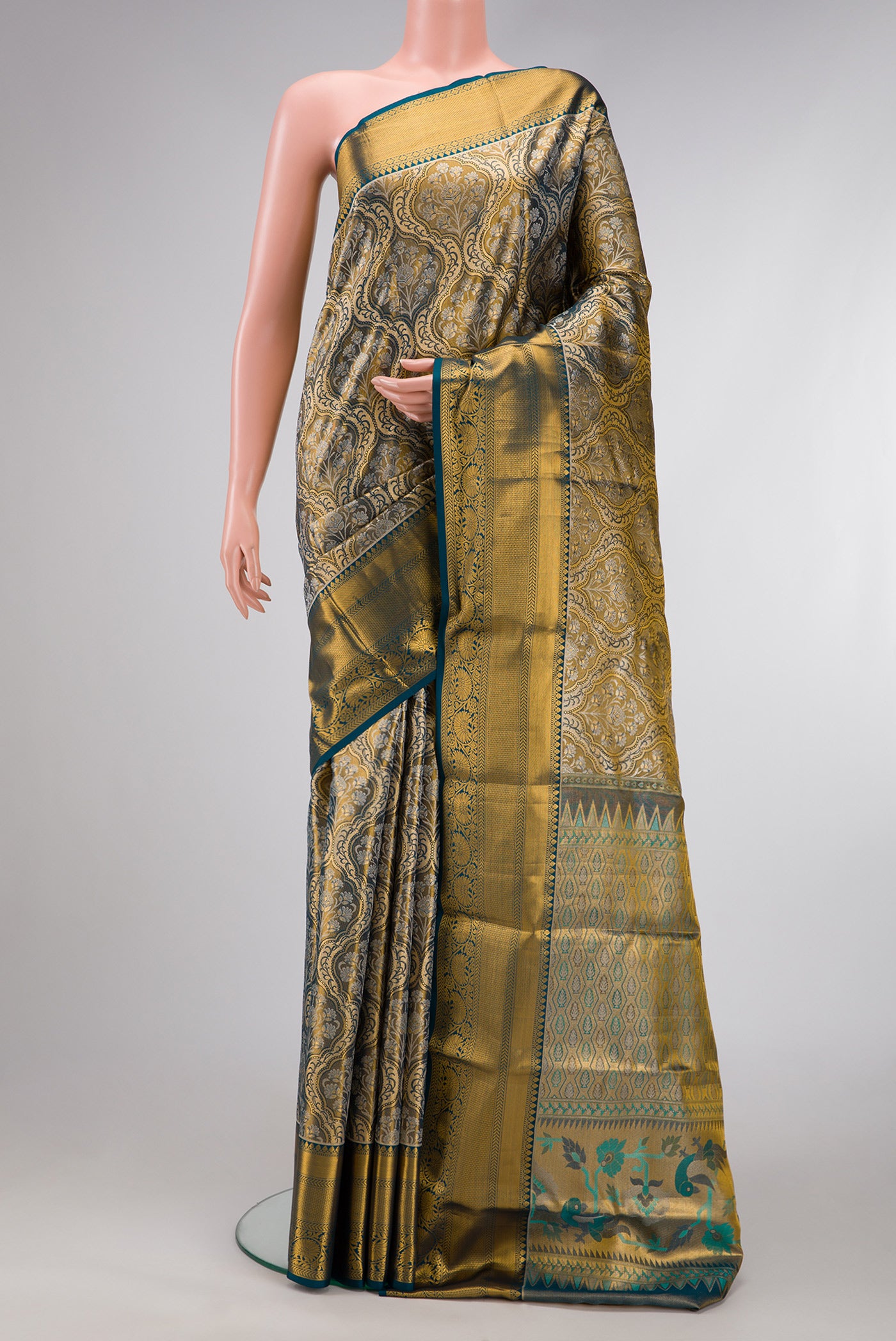 Mehandi Green Dual Tone Kanchipuram Tissue Silk Saree with Zari Brocade on the body and Zari Border.  displayed on a mannequin