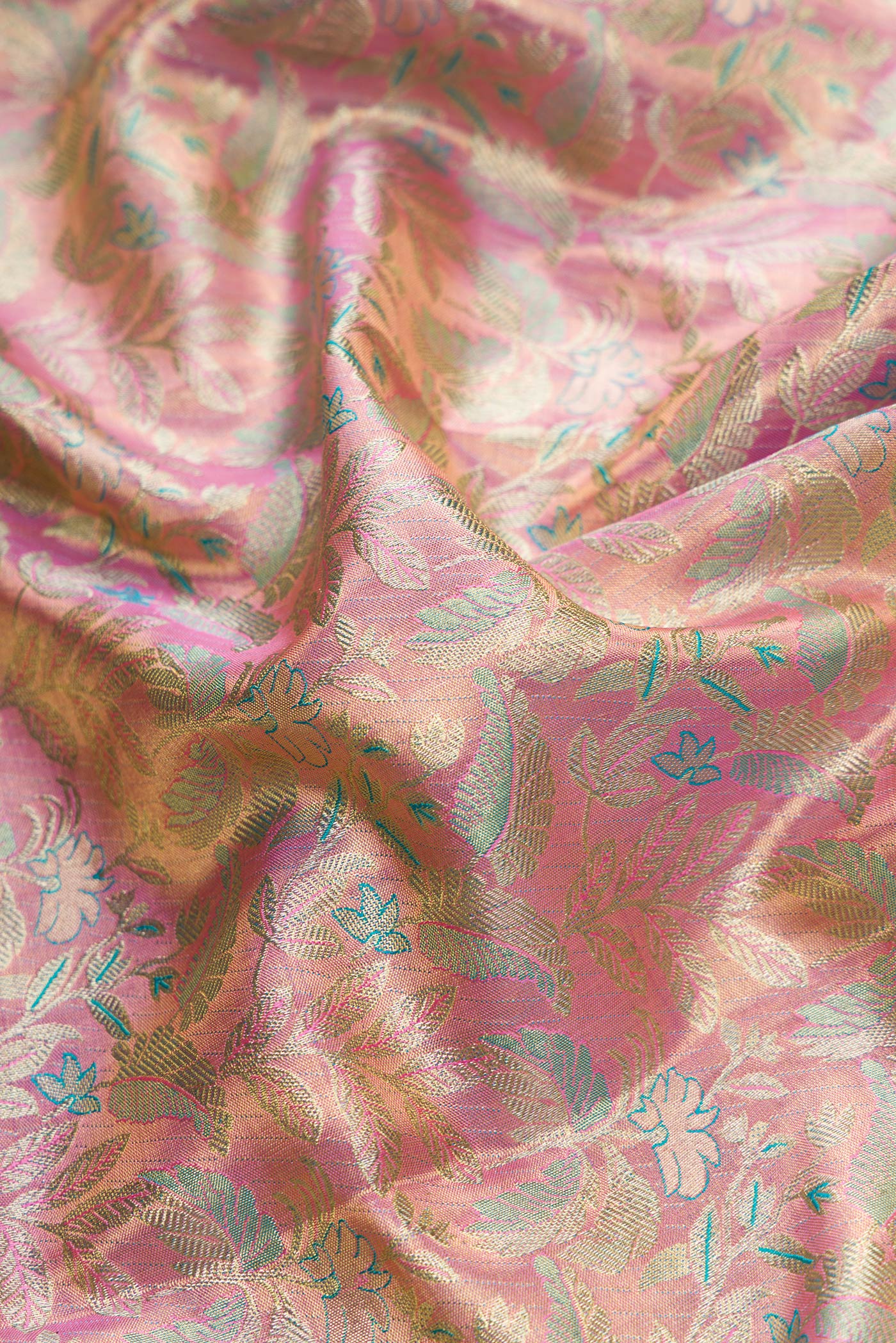 Close up of Pink Dual Tone Kanchipuram Tissue Silk Saree with Zari Brocade on the body and Zari Border.  displaying folds