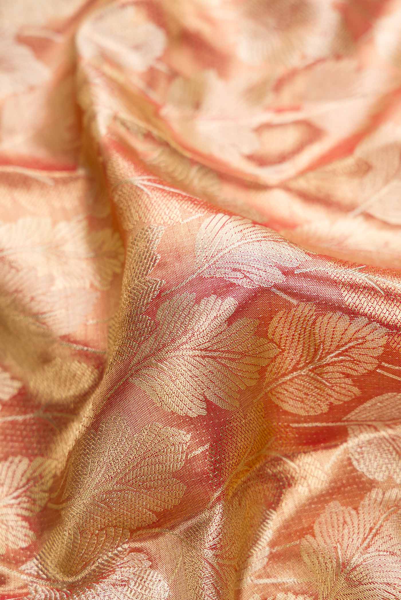 Close up of Maroon Dual Tone Kanjivaram Tissue Silk Saree with Zari Brocade on the body and Zari Border.  displaying folds