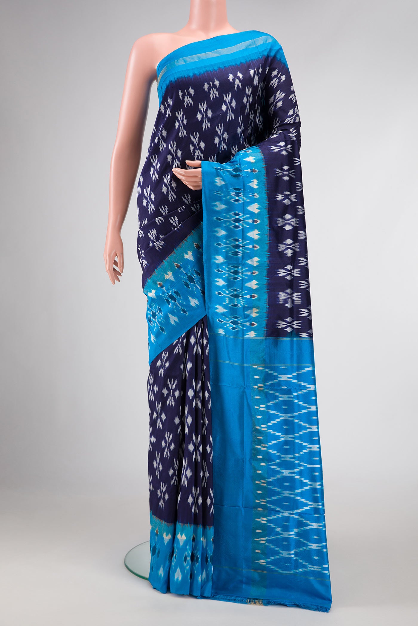 Navy Blue Dual Tone Double Ikat Saree with Ikat Print on the body and Ikat Border.  displayed on a mannequin