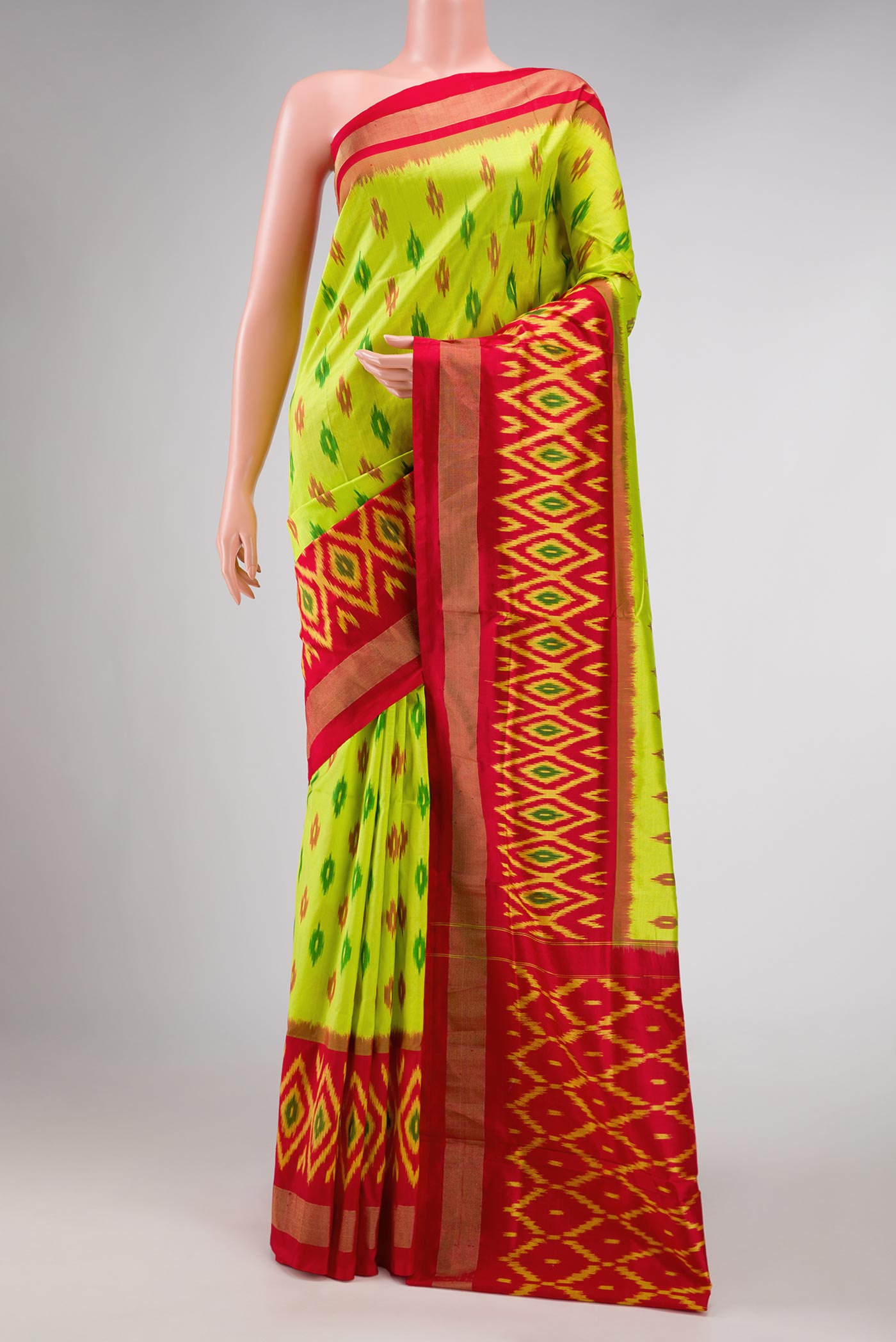 Parrot Green Dual Tone Double Ikat Saree with Ikat Print on the body and Ikat Border displayed on a mannequin