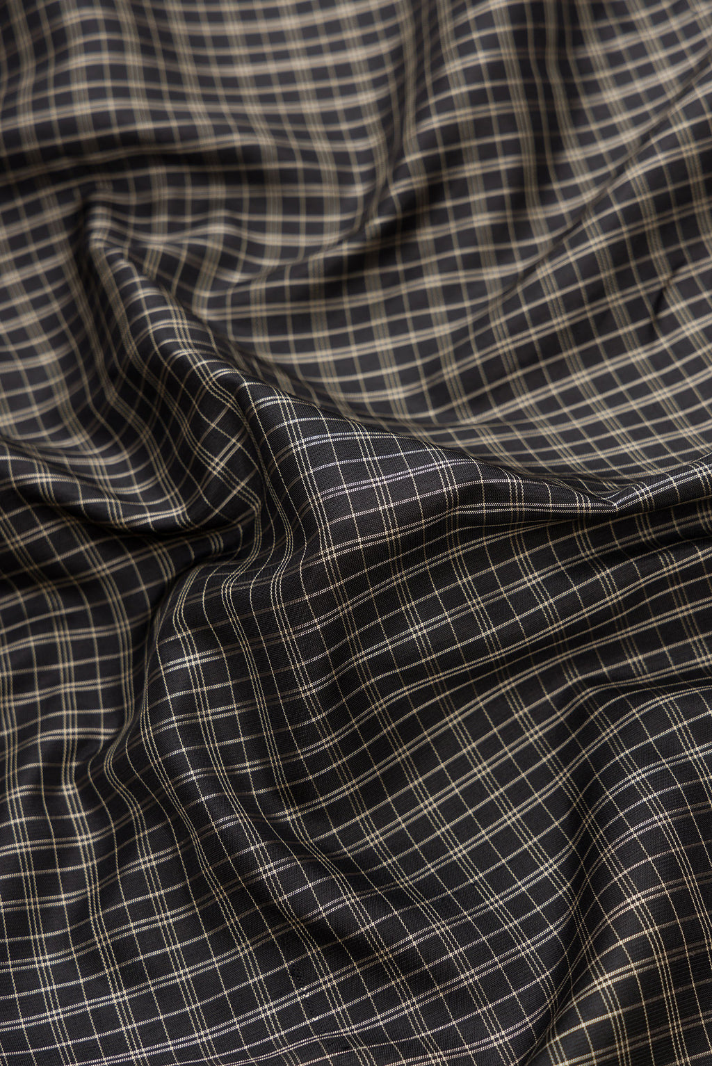 Close up of Black Dual Tone Gadwal Silk Saree with Checked design on the body and Temple Border.  displaying folds