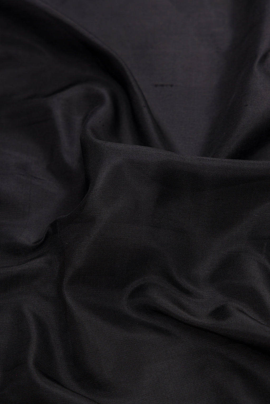 Close up of Black Dual Tone Gadwal Silk Saree with Plain Body and Thread Border.  displaying folds