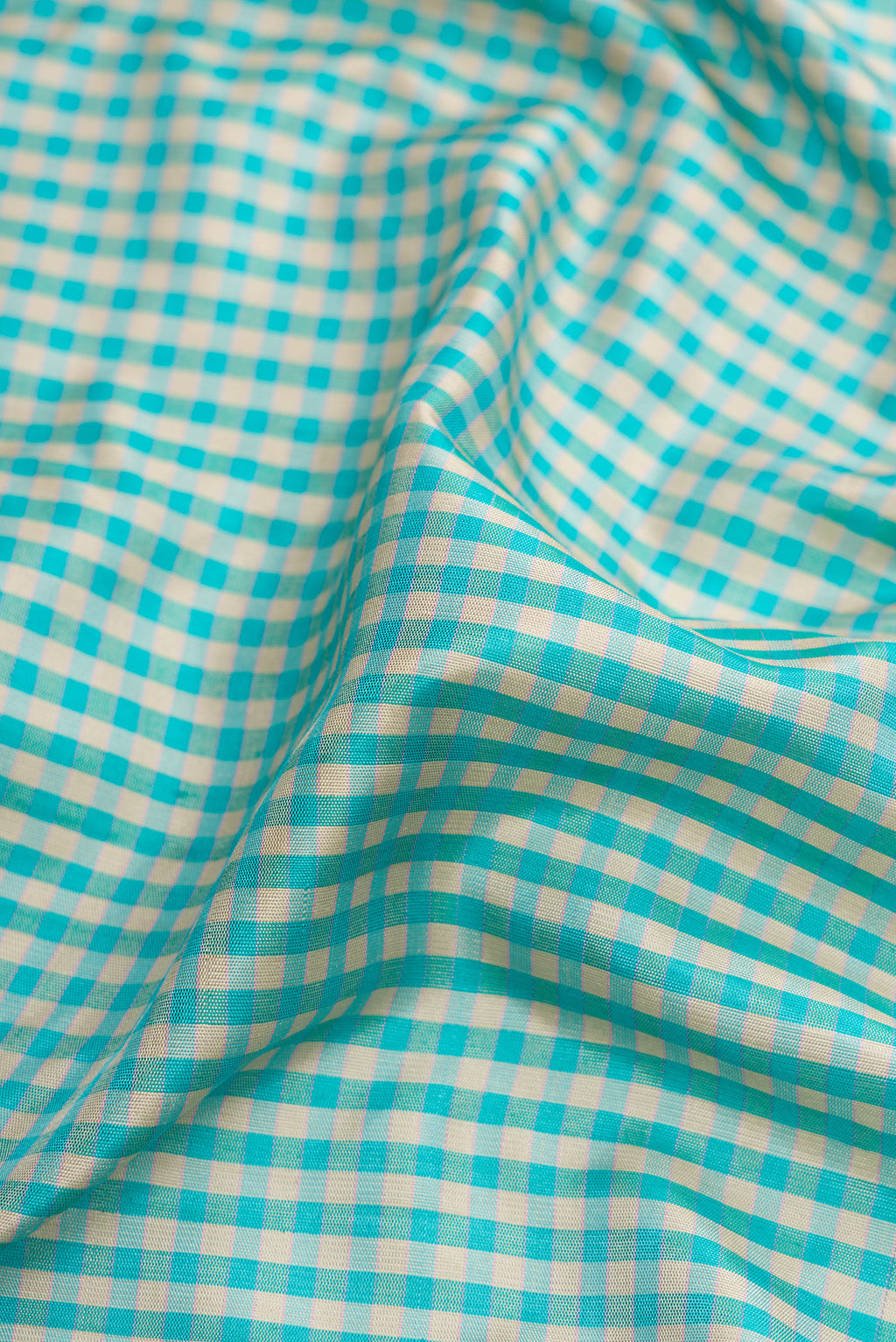 Close up of Light Blue Dual Tone Gadwal Silk Saree with Checked design on the body and Plain Border.  displaying folds