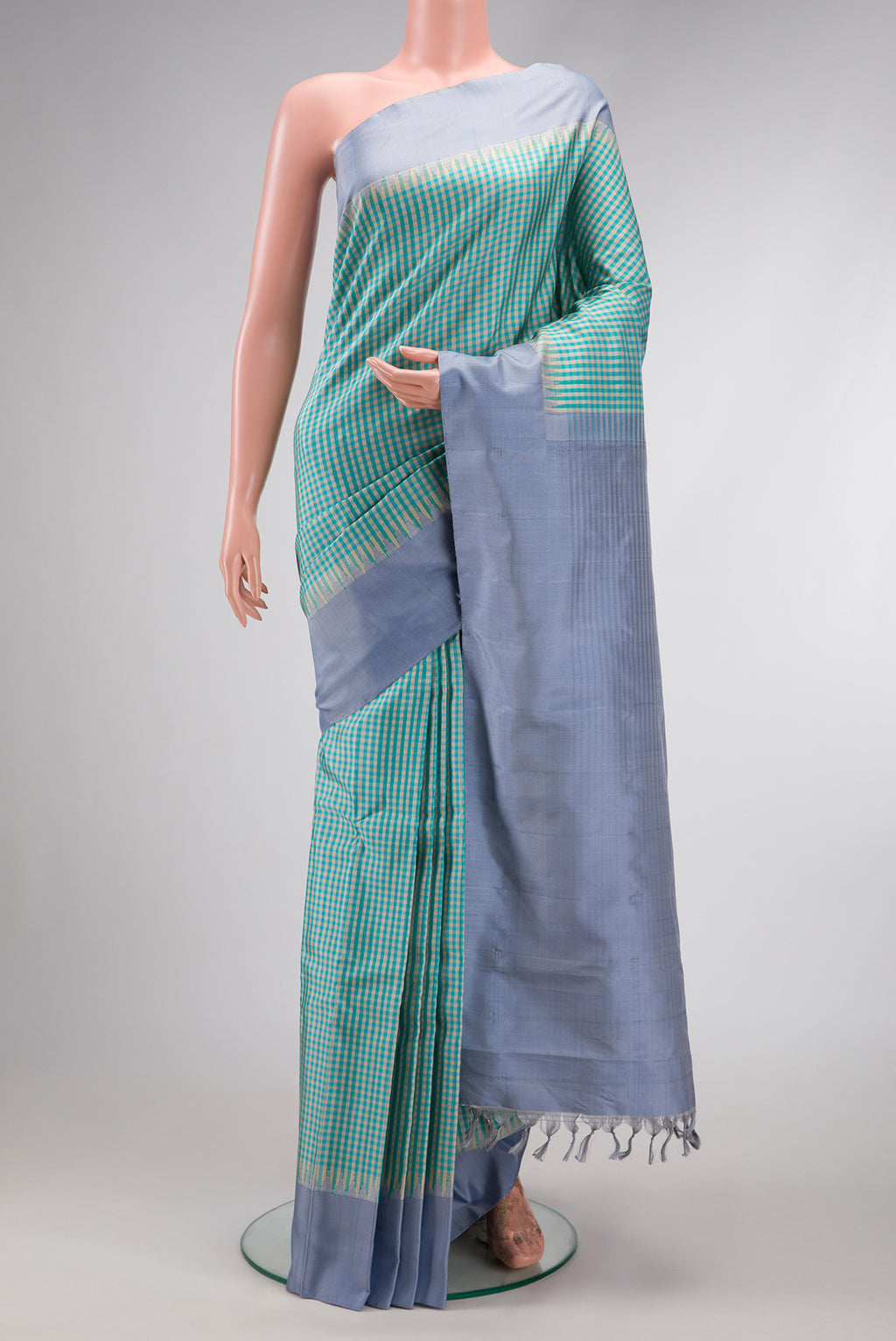 Light Blue Dual Tone Gadwal Silk Saree with Checked design on the body and Plain Border.  displayed on a mannequin