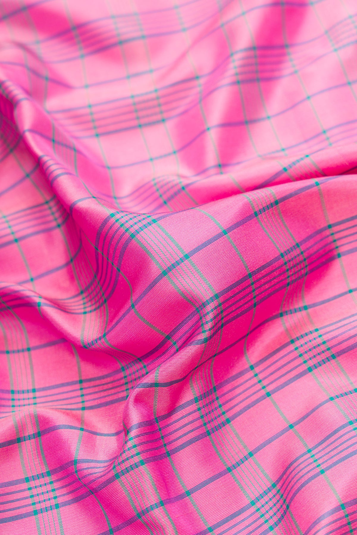 Close up of Pink Dual Tone Gadwal Silk Saree with Checked design on the body and Temple Border.  displaying folds
