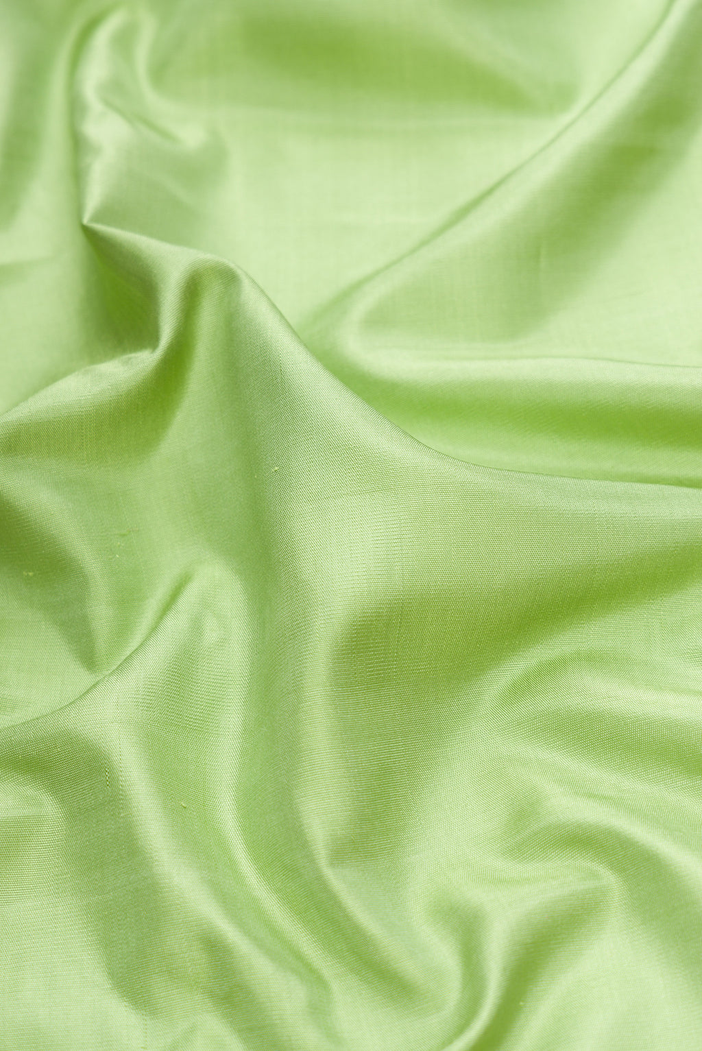 Close up of Pista Green Dual Tone Gadwal Silk Saree with Plain Body and Temple Border.  displaying folds