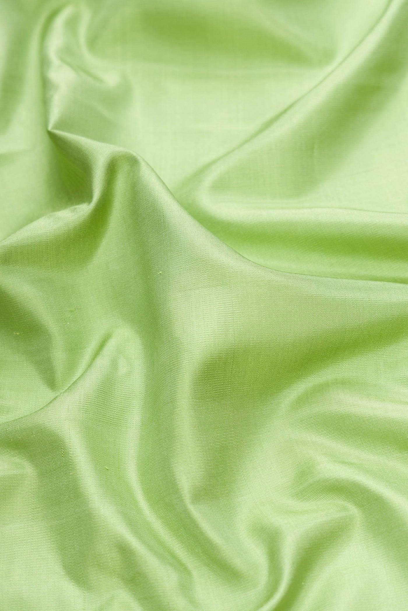 Close up of Pista Green Dual Tone Gadwal Silk Saree with Plain Body and Temple Border.  displaying folds