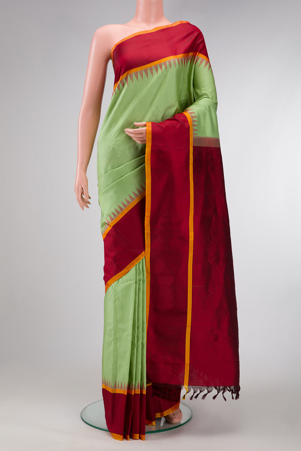 Pista Green Dual Tone Gadwal Silk Saree with Plain Body and Temple Border.  displayed on a mannequin
