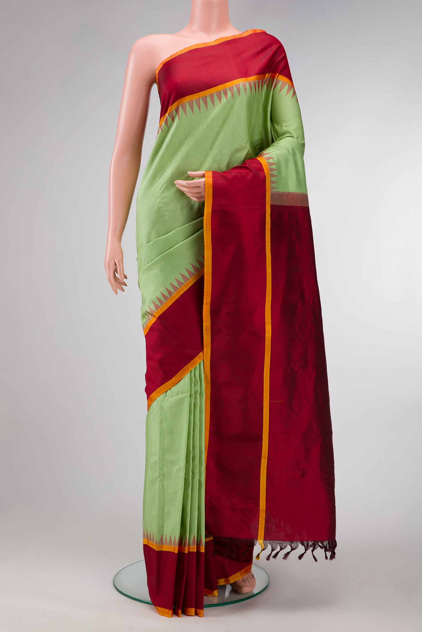 Pista Green Dual Tone Gadwal Silk Saree with Plain Body and Temple Border.  displayed on a mannequin