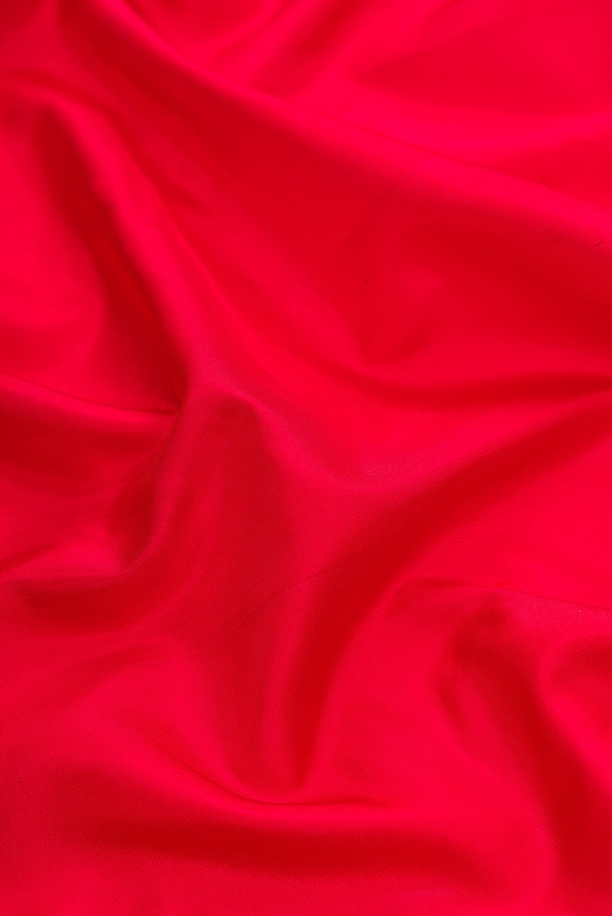 Close up of Red Dual Tone Gadwal Silk Saree with Plain Body and Temple Border.  displaying folds