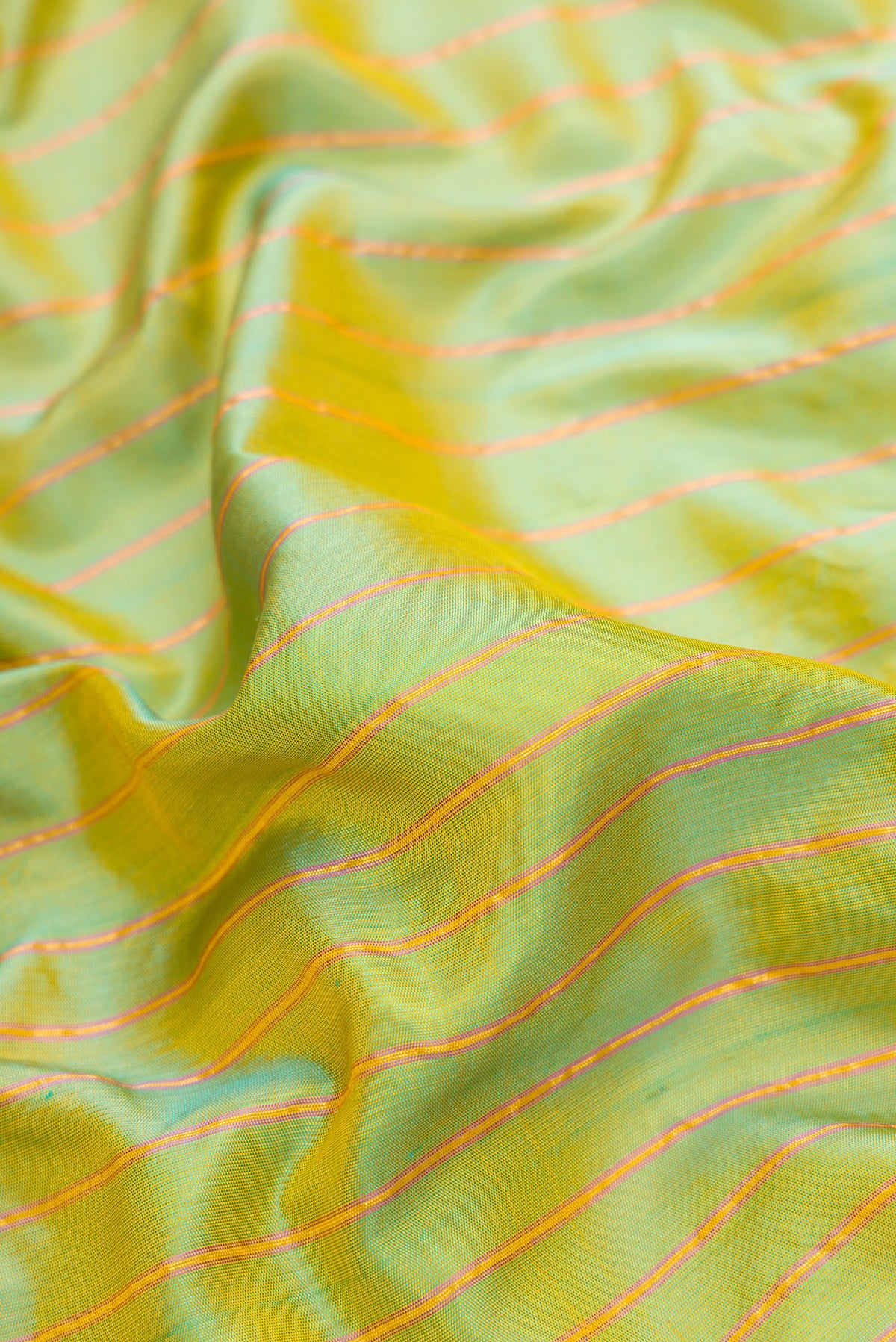 Close up of Green Dual Tone Gadwal Silk Saree with Stripes on the body and Plain Border.  displaying folds